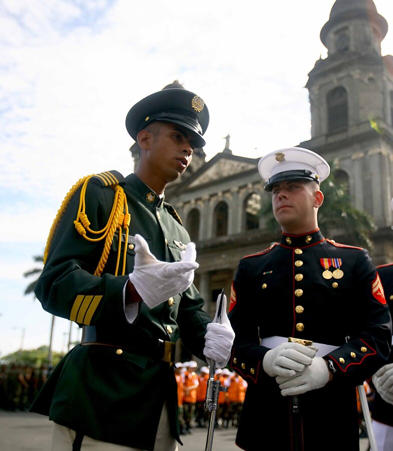Cpl. Nick Hefley talks with a member of the Nicaraguan military before the Nicaraguan Armed Forces 30th Anniversary Celebration, Sept. 12 in Managua, Republic of Nicaragua. Hefley is a squad leader with 2nd Platoon, Company A, Marine Barracks Washington.