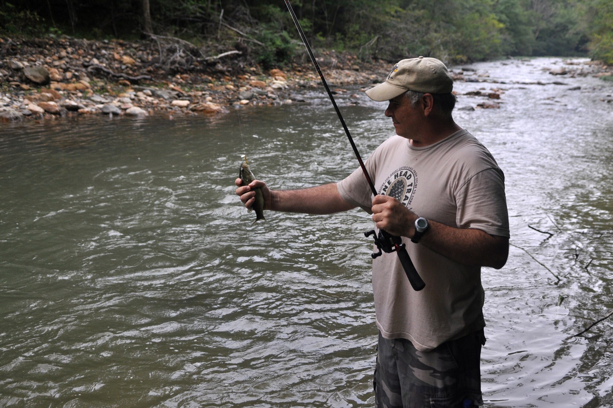 Master Sgt. Greg Steele, visual information specialist, 47th Fighter Squadron, lands a small-mouth bass on the Little Missouri River in Arkansas’ Ouachita National Forest, Sept. 5, 2009. Sergeant Steele was attending the 2nd Annual Un-Official 917th Wing Public Affairs Retreat, which is used to relieve stress, boost morale and build a sense of team cohesiveness within the public affairs office.  (Photo by Jeff Walston)
