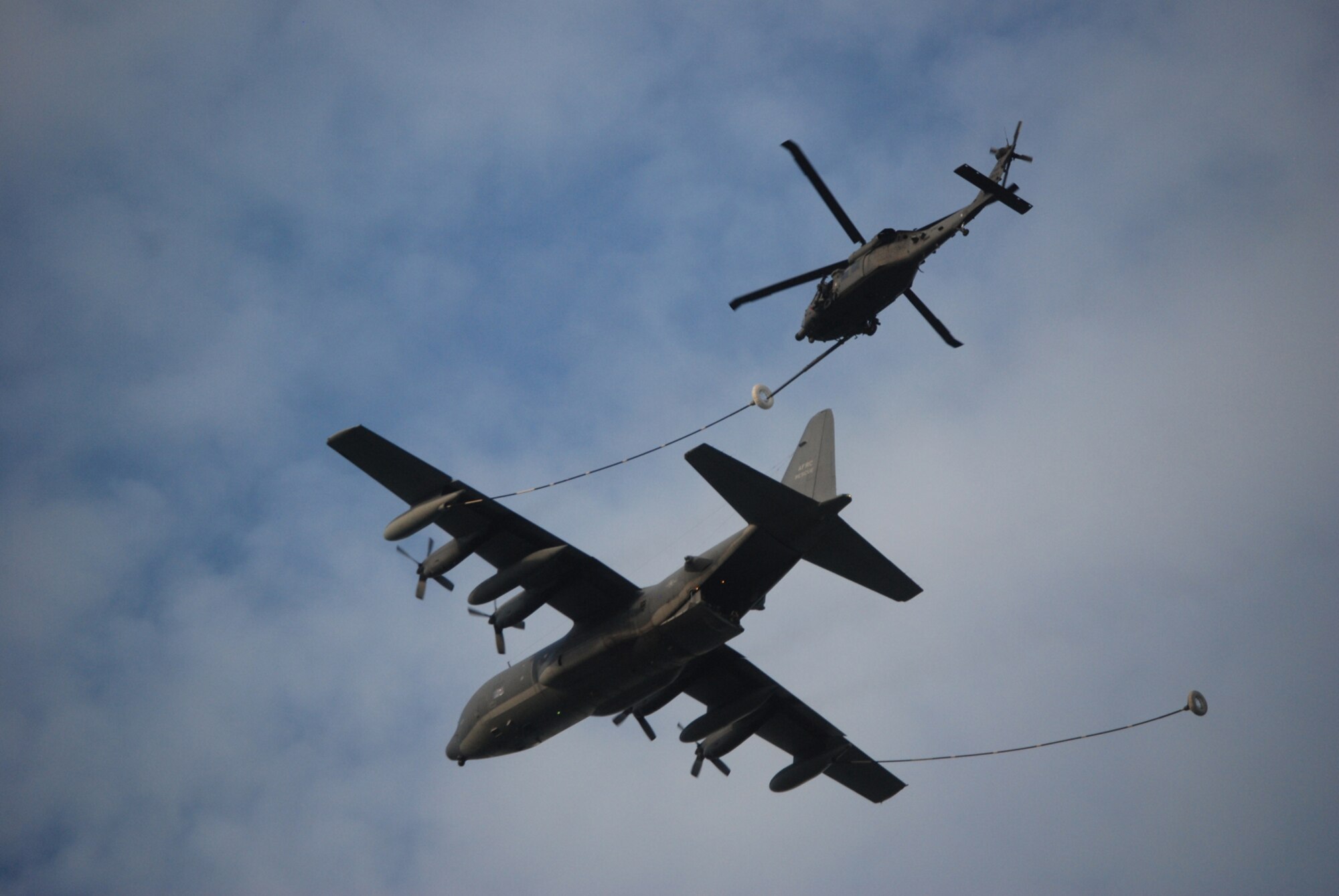 COCOA BEACH, Fla. -- An Air Force Reserve HC-130P/N and HH-60G Pave Hawk conduct a simulated refueling mission in the skies over the Atlantic Ocean off Cocoa Beach before local civic leaders, citizens of and visitors to the Cocoa Beach community and military members during a ceremony honoring military men and women, both past and present from the area Sept. 11 at a local restaurant on Cocoa Beach. The 920th Rescue Wing conducted a Search and Rescue operation involving Pararescuemen parachuting from unit-equipped HC-130P/N aircraft into the ocean and a rescue operation with the unit's HH-60G Pave Hawk helicopter which also performed during a air-to-air refueling demonstration with the HC-130P/N. The 920th Rescue Wing will conduct similar capability demonstrations during the Cocoa Beach air show scheduled for October 2-4 at Alan Shepard Park along Highway A1A in. U.S. Air Force photo/Master Sgt. Bryan Ripple