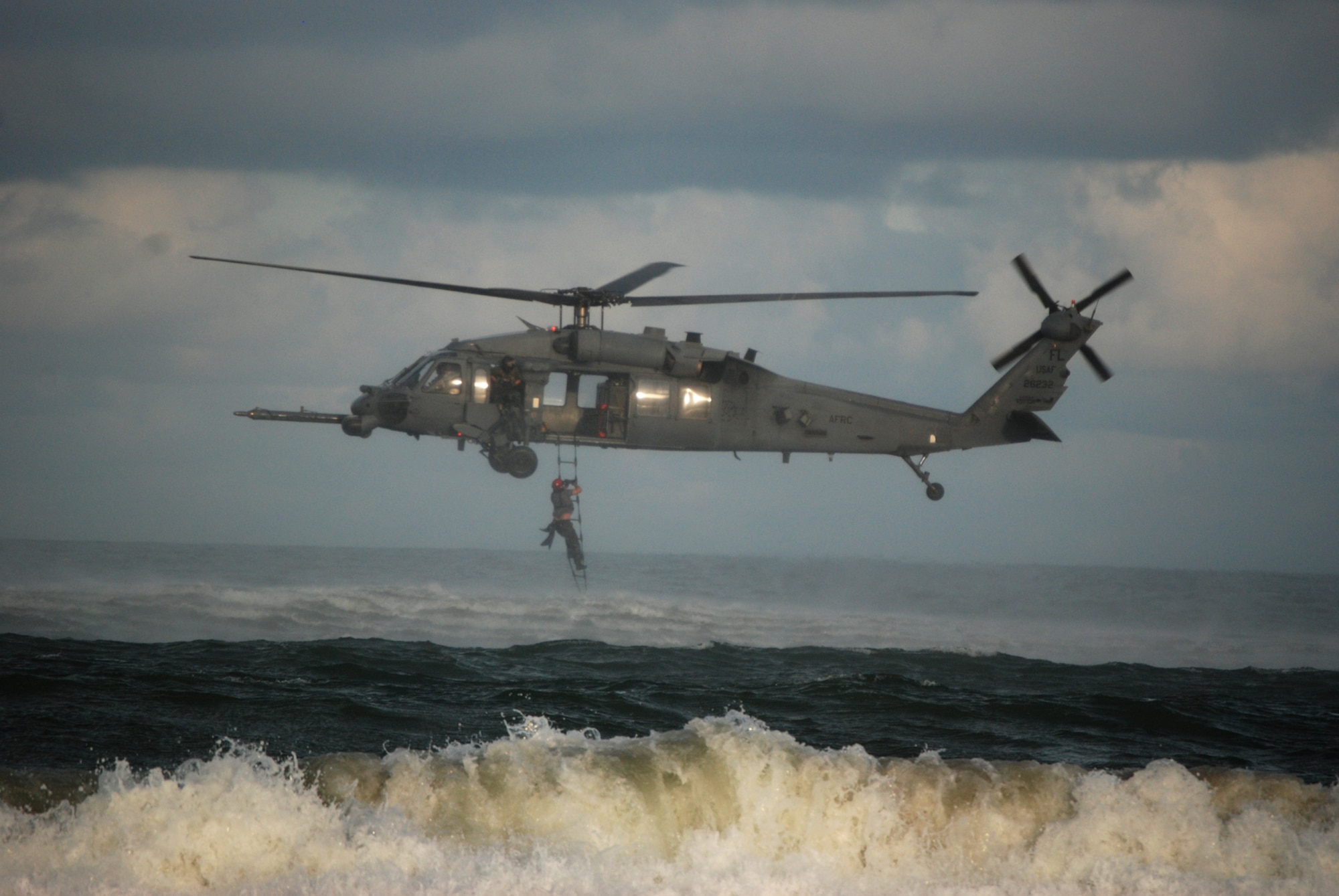 COCOA BEACH, Fla. -- Air Force Reserve HG-60G Pave Hawk aircrew members and pararescuemen from the 920th Rescue Wing perform a rescue demonstration in the Atlantic Ocean off Cocoa Beach in front of local civic leaders, citizens of and visitors to the Cocoa Beach community and military members during a ceremony honoring military men and women, both past and present from the area Sept. 11 at a local restaurant on Cocoa Beach. The 920th Rescue Wing conducted a Search and Rescue operation involving Pararescuemen parachuting from unit-equipped HC-130P/N aircraft into the ocean and a rescue operation with the unit's HH-60G Pave Hawk helicopter which also performed during a air-to-air refueling demonstration with the HC-130P/N. The 920th Rescue Wing will conduct similar capability demonstrations during the Cocoa Beach air show scheduled for October 2-4 at Alan Shepard Park along Highway A1A in. U.S. Air Force photo/Master Sgt. Bryan Ripple