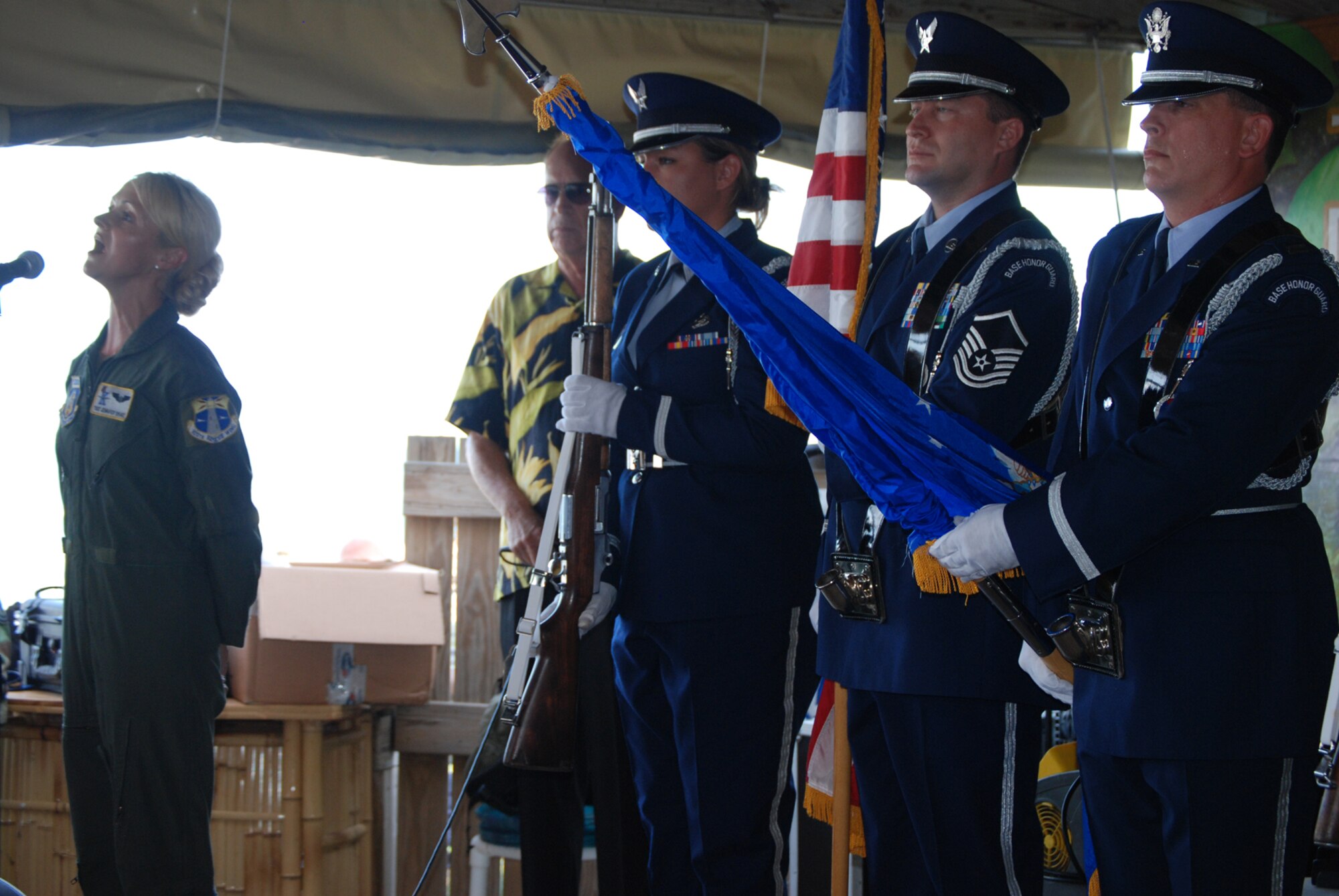 COCOA BEACH, Fla. -- Air Force Reserve Tech. Sgt. Jennifer Drake, Combat Rescue Radio Operator on 920th Rescue Wing HC-130P/N aircraft sings the National Anthem during a ceremony honoring military men and women, both past and present from the area during a ceremony held Sept. 11 at a local restaurant on Cocoa Beach. The 920th Rescue Wing conducted a Search and Rescue operation involving Pararescuemen parachuting from unit-equipped HC-130P/N aircraft into the ocean and a rescue operation with the unit's HH-60G Pave Hawk helicopter which also performed during a air-to-air refueling demonstration with the HC-130P/N. The 920th Rescue Wing will conduct similar capability demonstrations during the Cocoa Beach air show scheduled for October 2-4 at Alan Shepard Park along Highway A1A in. U.S. Air Force photo/Master Sgt. Bryan Ripple