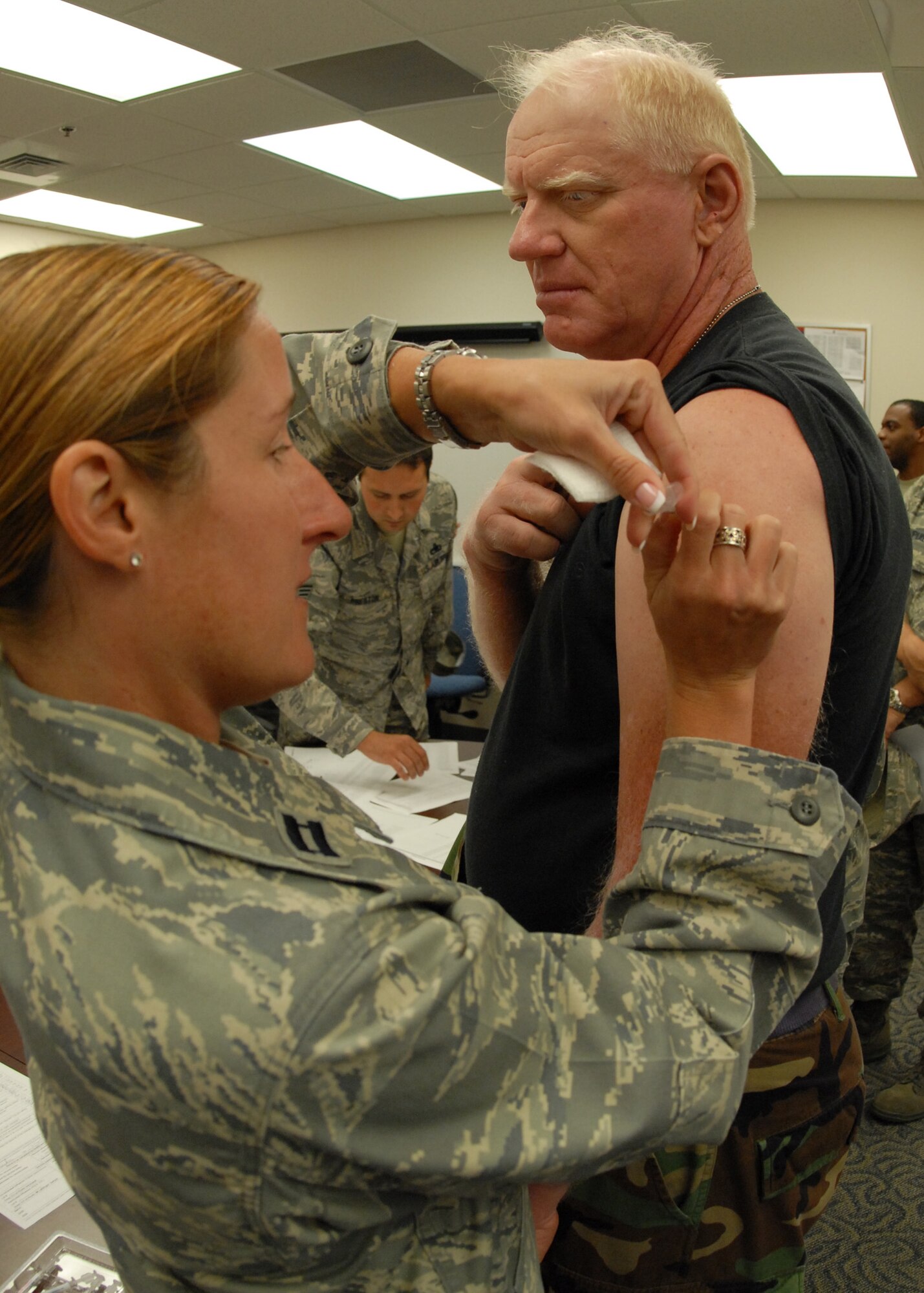 Capt. Courtney Wilson, 919th Medical Squadron, administers a flu shot to Tech Sgt. Robert Decker, 919th Communications Squadron, Sept. 12  at Duke Field during the UTA weekend.  (U.S. Air Force photo/Staff Sgt. Samuel King Jr.)