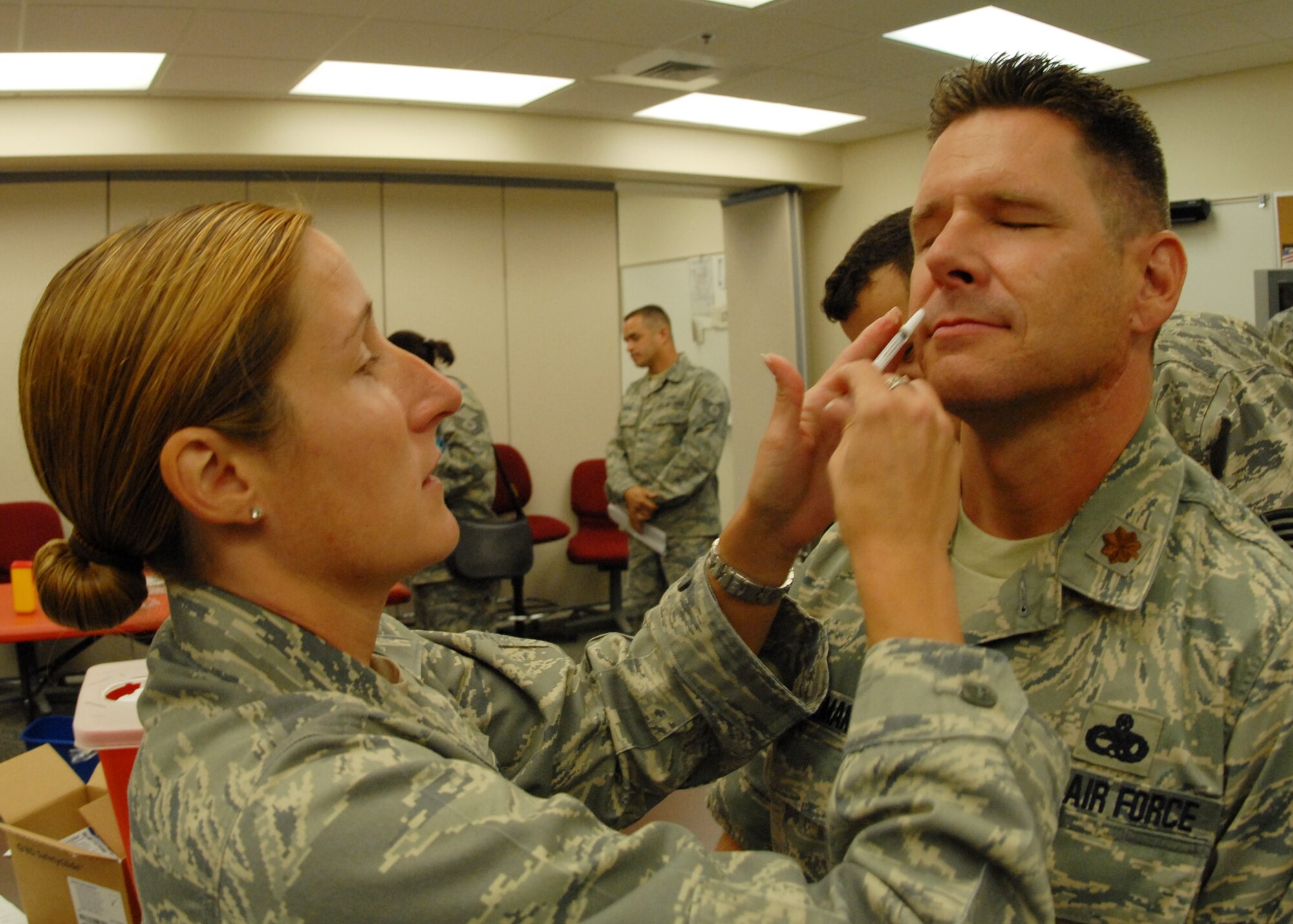 Capt. Courtney Wilson, 919th Medical Squadron, administers the flu-mist to Maj. Matthew Heintzelman, 919th Maintenance Group, Sept. 12 at Duke Field during the UTA weekend.  (U.S. Air Force photo/Staff Sgt. Samuel King Jr.)