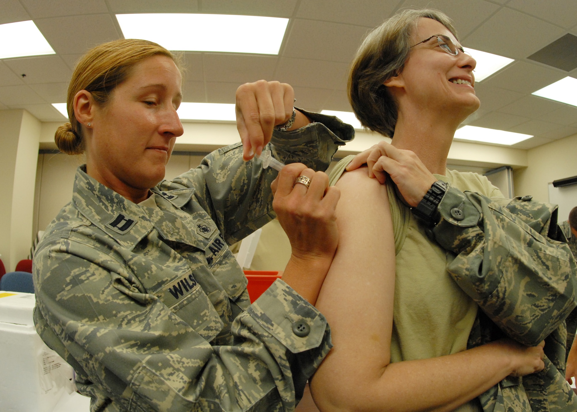 Capt. Courtney Wilson, 919th Medical Squadron, administers a flu shot to Lt. Col. Nancy Kirk, 919th Maintenance Group, Sept. 12 at Duke Field during the UTA weekend.  (U.S. Air Force photo/Staff Sgt. Samuel King Jr.)