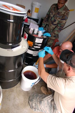 Master Sgt. Scott McIntosh, bio-environmental engineer, 103rd Medical Group, helps Senior Airman Auttdomm Dy, vehicle maintenance technician, 103rd Logistics Readiness Squadron, Bradley ANG Base, East Granby, Conn., properly fit a respirator. McIntosh’s job is to help ensure the working environment is safe and, if dangers are present, that personal protective equipment is in good condition.  (U.S. Air Force photo by Tech. Sgt. Josh Mead)
