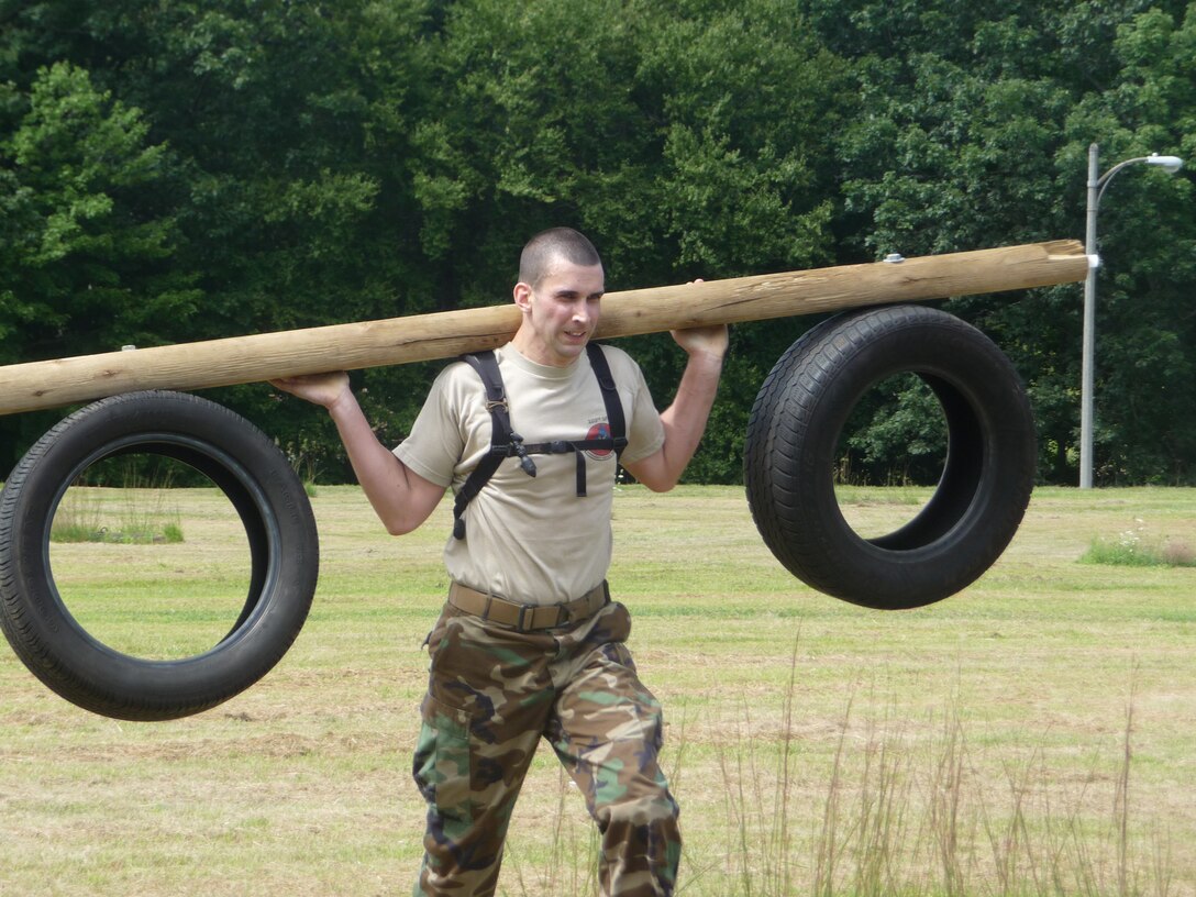 Staff Sgt. Chris Sixt grimaces as he carries the load during the log and tire relay portion of the CT SWAT Challenge in West Hartford, Conn. Aug. 27, 2009. (Photo courtesy of Staff Sgt. Jessica Roy)
