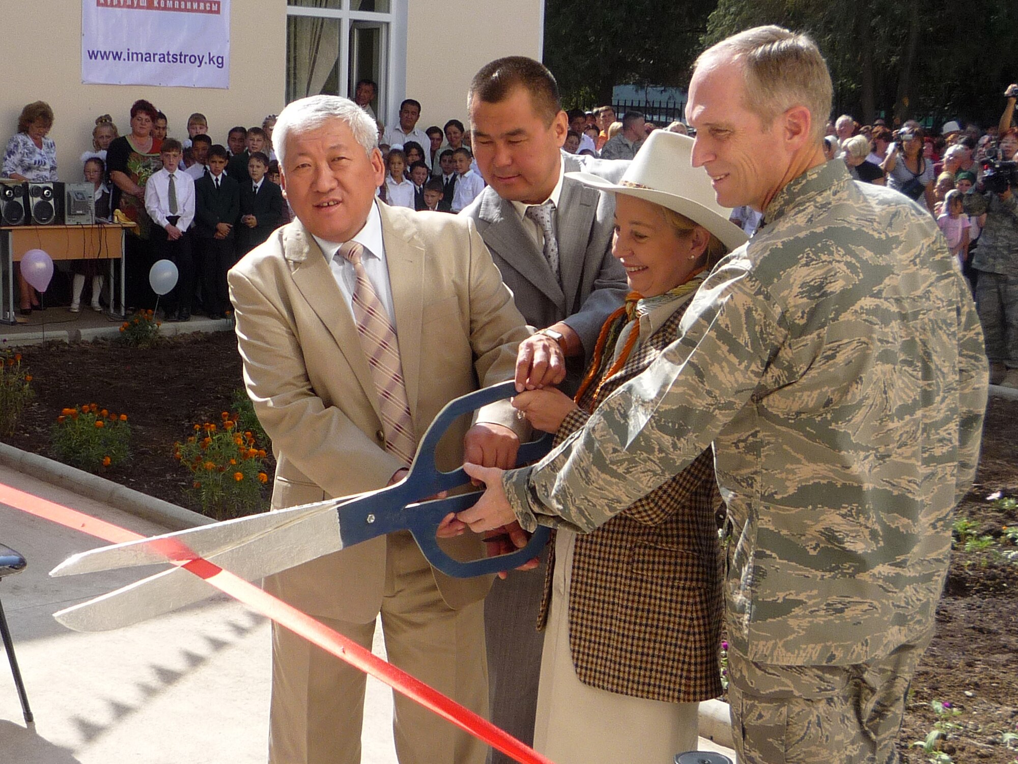 BISHKEK, Kyrgyzstan - (Right) Lt. Gen. Michael Hostage, U.S. Air Forces Central Command commander, The Honorable Tatiana Gfoeller, U.S. Ambassador to Kyrgyzstan, Mr. Madalbek Toktobolotov, Chui Province 1st deputy governor, and Mr. Marat Kutanov, Chui Province Alamudun District 1st deputy mayor, cut the ribbon to the Birdik Village School on Sept. 1, 2009. Airmen and local Kyrgyz citizens from the Village of Birdik teamed together to renovate a school that officially began construction in April 2009. (U.S. Air Force/Courtesy Photo)
