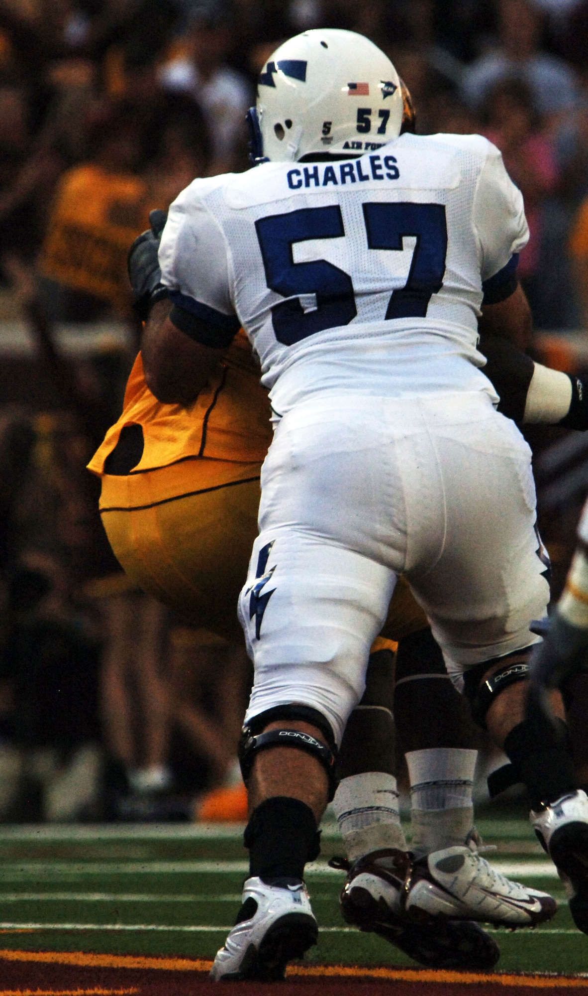 Air Force's Nick Charles delivers a punishing block to a Minnesota defensive player at Falcons-Gophers game in Minneapolis Sept. 12, 2009. The Falcon offensive lineman was placed on the 2009 Outland Trophy watch list as well as given first-team preseason all-Mountain West Conference honors. (U.S. Air Force photo/2nd Lt. Meredith Kirchoff)