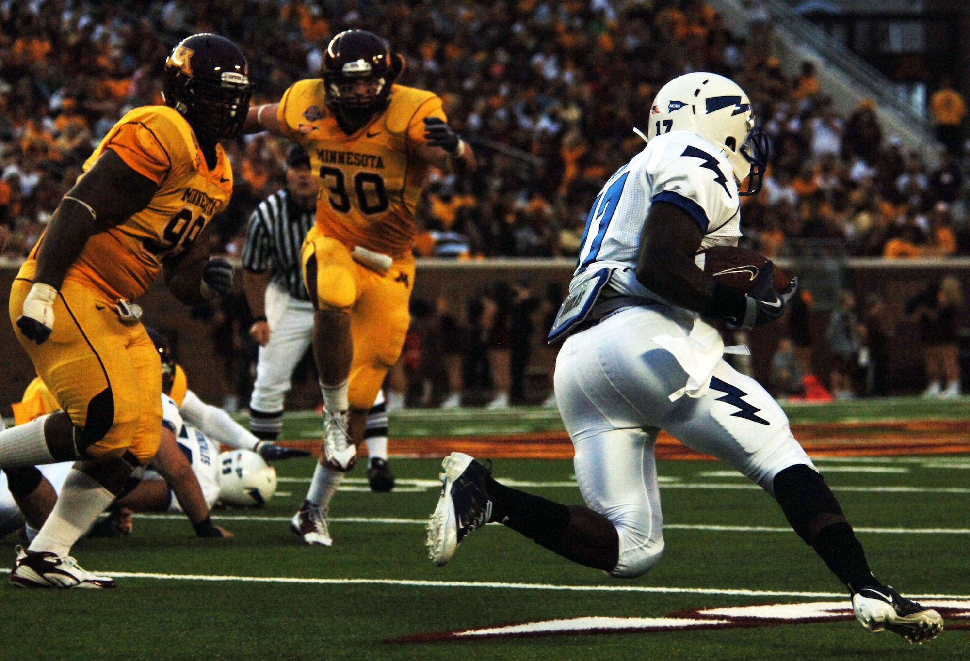 Air Force running back Asher Clark rushes down the field in the Falcons' Sept. 12, 2009 matchup against  the Minnesota Gophers at TCF Bank Stadium in Minneapolis. Clark, a sophomore from Lawrenceville, Ga., lead the Falcons in rushing with 90 yards on 12 carries. (U.S. Air Force photo/2nd Lt. Meredith Kirchoff)