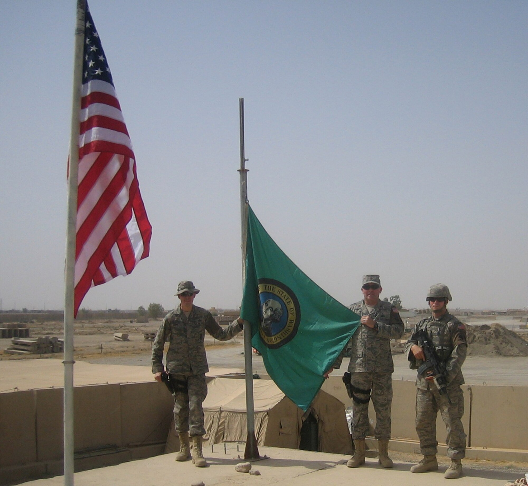 KIRKUK AIR BASE, Iraq.- Reservists with the 446th Security Forces Squadron, McChord Air Force Base, Wash., participate in the Patriot Day ceremony at the command post here Sept. 11. Staff Sgt. Greg Marek, left, Maj. Ray Schierhoff, center, and Staff Sgt. Dave Roberts are all Washington State Troopers in their civilian careers and are assigned to the 506th Air Expeditionary Group here as part of their air expeditionary force rotation in support of the operations in Southwest Asia. The unit has been in place since July. (U.S Air Force photo/Senior Master Sgt. Don Souron) 