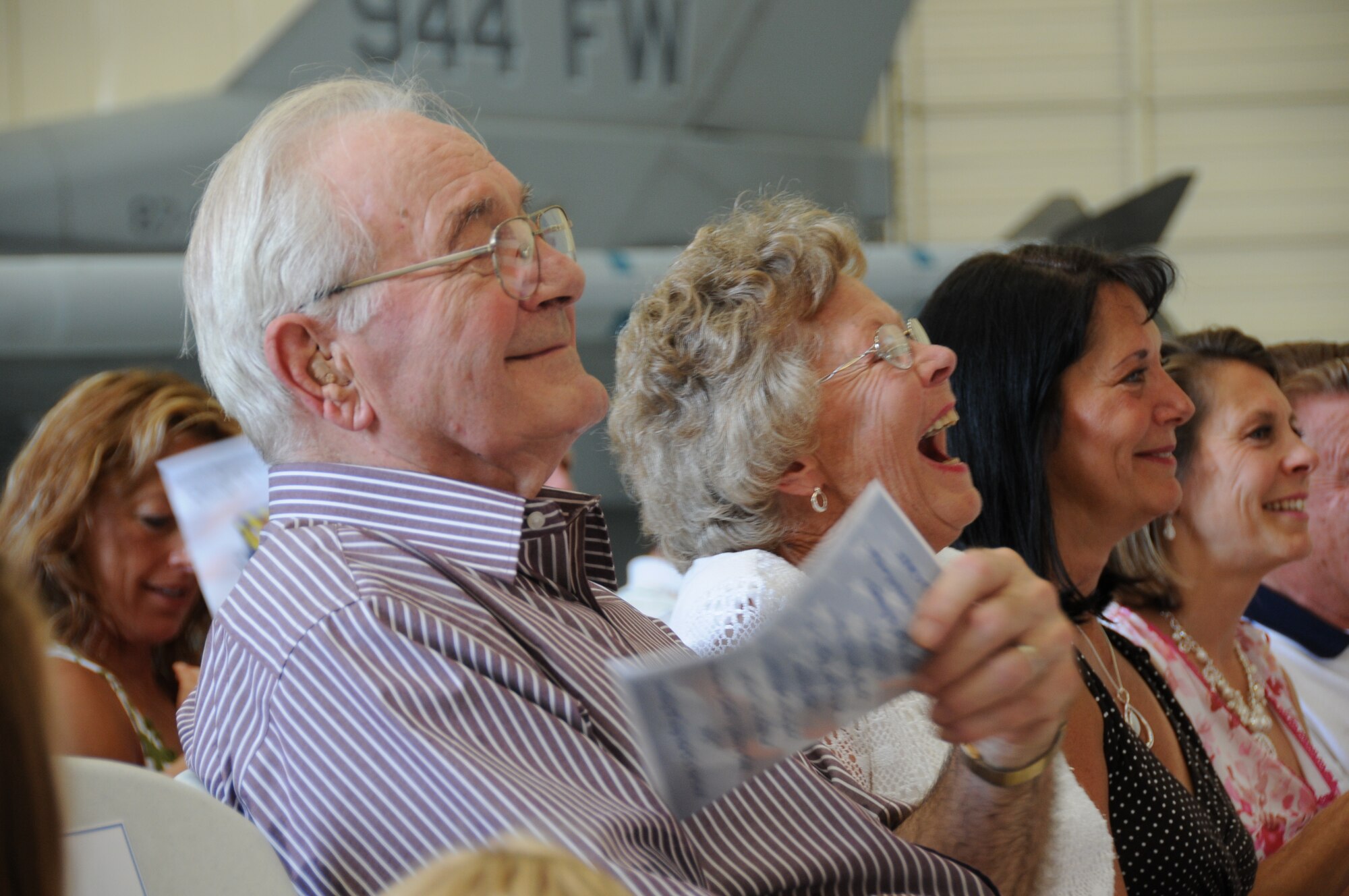 Frank and Geraldine Garfield, parents of Lt. Col. David Garfield, laugh as he describes them during his speech after assuming command of the 944th Operations Group Sept. 11. (U.S. Air Force photo/Tech. Sgt. Susan Stout)