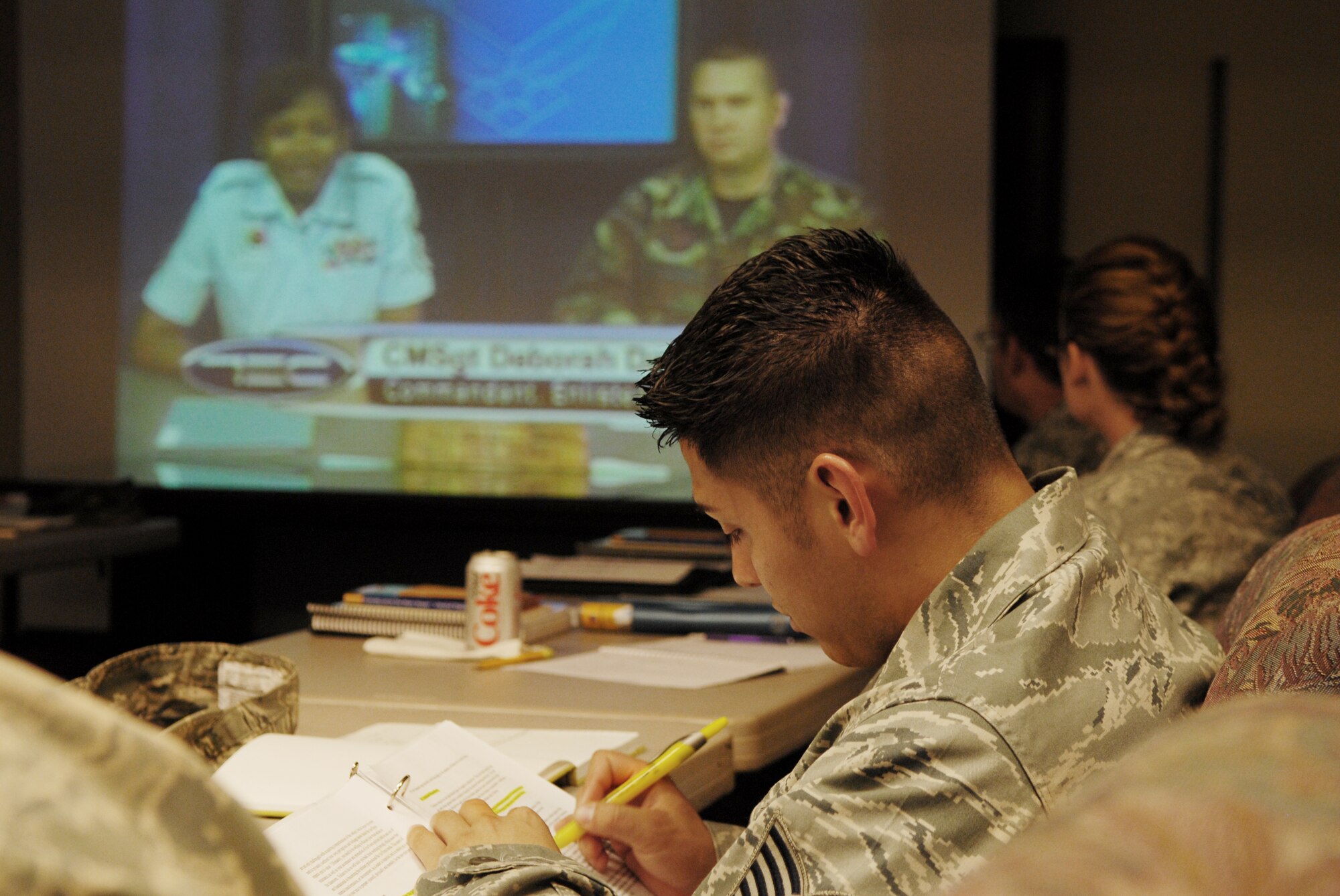 Tech. Sgt. Jesse Hernandez, a medical material technician with the Texas Air National Guard’s 149th Fighter Wing, highlights key points contained in a satellite NCO Academy training manual while listening to Chief Master Sgt. Deborah F. Davidson, commandant of Enlisted Professional Military Education for the Air National Guard, via satellite connection, at Lackland Air Force Base, Texas, on Sept. 10, 2009. (U.S. Air Force photo by Staff Sgt. Eric L. Wilson)(RELEASED).