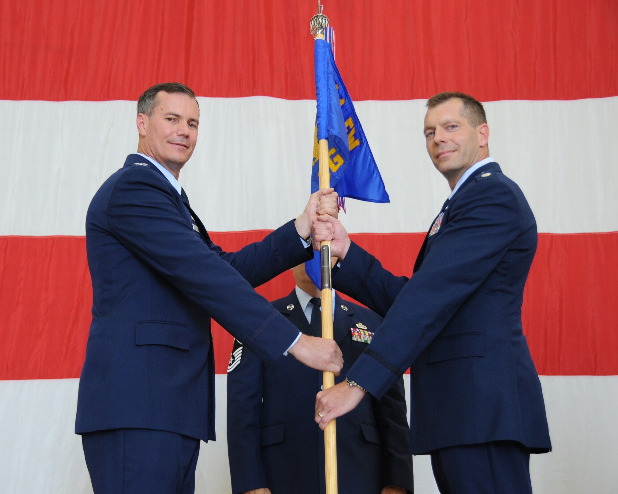 LUKE AIR FORCE BASE, Ariz. -- Col. Michael Popovich, 944th Fighter Wing commander, presents Lt. Col. David Garfield, 944th Operations Group commander, the unit guidon during the 944th OG change of command ceremony Sept. 11 here. (U.S. Air Force photo/Tech. Sgt. Susan Stout) 