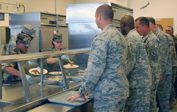 Senior Airman Destiny Clark, 131st Force Support Squadron services troop, and Senior Airman Jessica Kile, 131st FSS services troop, serve Airmen and Soldiers Sept. 12 at the 157th Air Operations Group Air National Guard Dining Facility at Jefferson Barracks. The 131st FSS Services section worked with the Army to feed more than 350 troops September Unit Training Assembly. (Photo by Senior Airman Jessica Donnelly) 