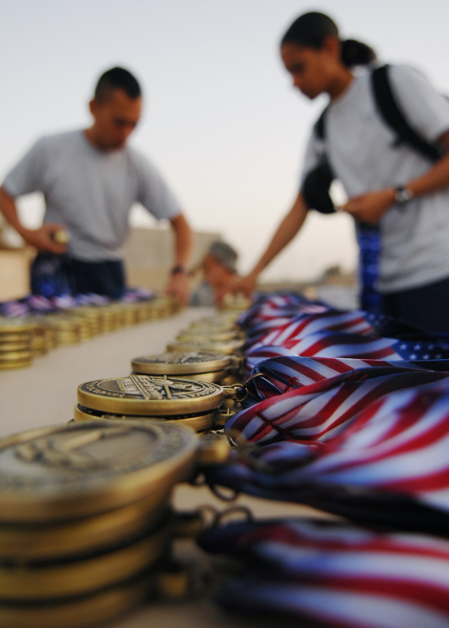 JOINT BASE BALAD, Iraq - Volunteers place medals on a table for participants in the Air Force Half Marathon at Holt Stadium here Sept. 11, 2009. The half marathon at JBB was one of four held at various bases in the AOR that is an officially-sanctioned part of the Air Force Half Marathon to be held Sept. 19, 2009, at Wright Patterson Air Force Base.  (U.S. Air Force photo/Senior Airman Christopher Hubenthal)