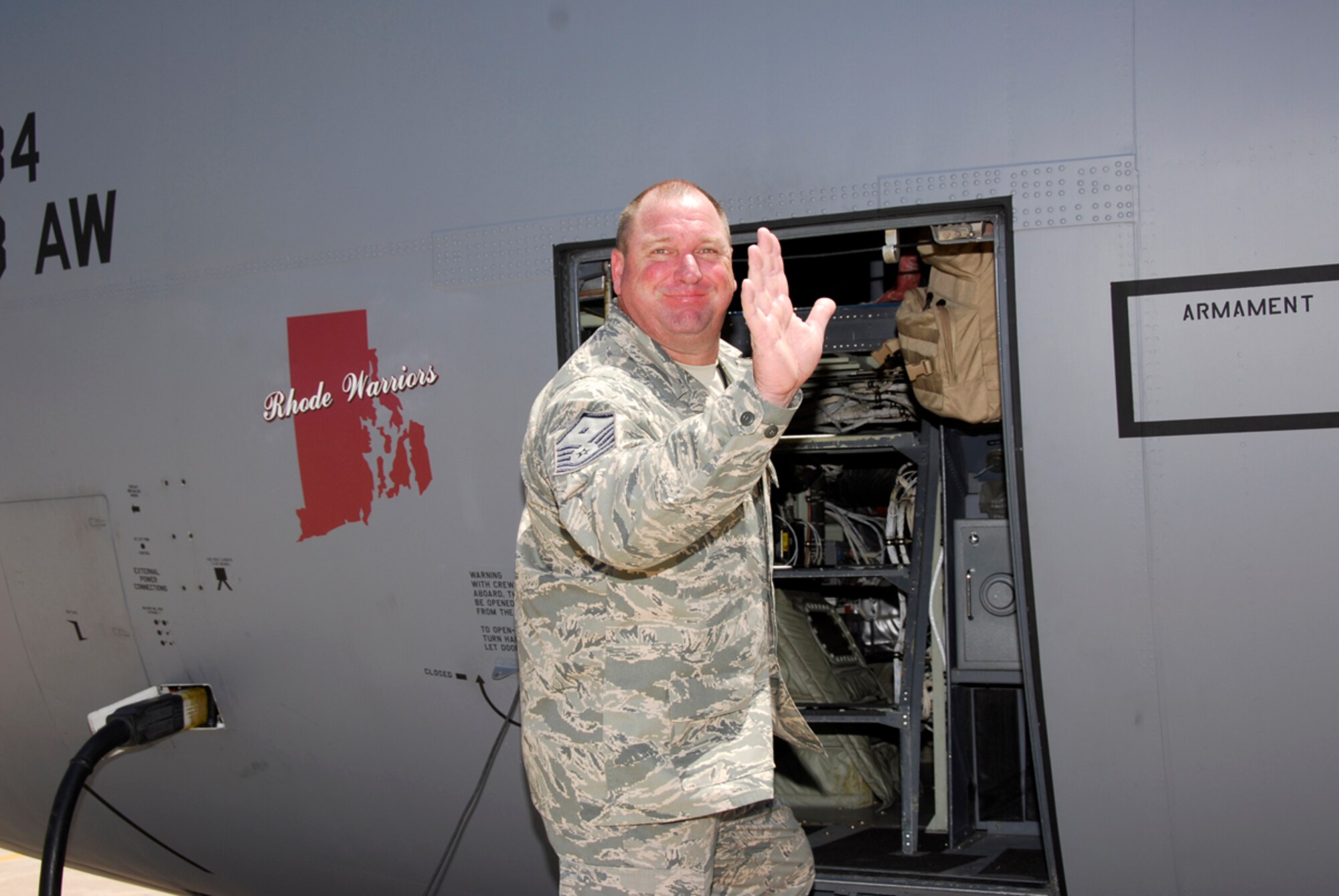 Master Sgt. Mike Moffett, a first sergeant with the 188th Fighter Wing's Civil Engineer Squadron, waves to his family July 24 just before boarding a C-130 prior to departing Fort Smith, Ark., for a six-month deployment to Guantanamo Bay, Cuba. The 188th CES deployed approximately 50 personnel to Guantanamo Bay. (U.S. Air Force photo by Senior Master Sgt. Dennis Brambl/188th Fighter Wing Public Affairs