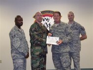 Staff Sgt. Steven Gatlin receives his diploma as part of the last graduating class from the Radio Communications Operator Apprentice Course at Keesler Air Force Base, Miss. (U.S. Air Force Photo/Unknown)