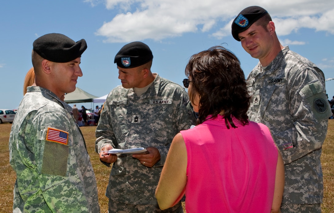 A group of soldiers speak to one of the non-profit organization representatives about the impact of each contribution made toward the Combined Federal Campaign Sept. 14 at Bordelon Field. The CFC kick off event was held to recognize U.S. Marine Corps Forces, Pacific as the executive agent for the upcoming yearlong term while displaying a variety of charities recognized by the CFC to remind federal employees the immense assistance they receive as a result of their support. (Official U.S. Marine Corps photo by Cpl. Achilles Tsantarliotis)(Released)