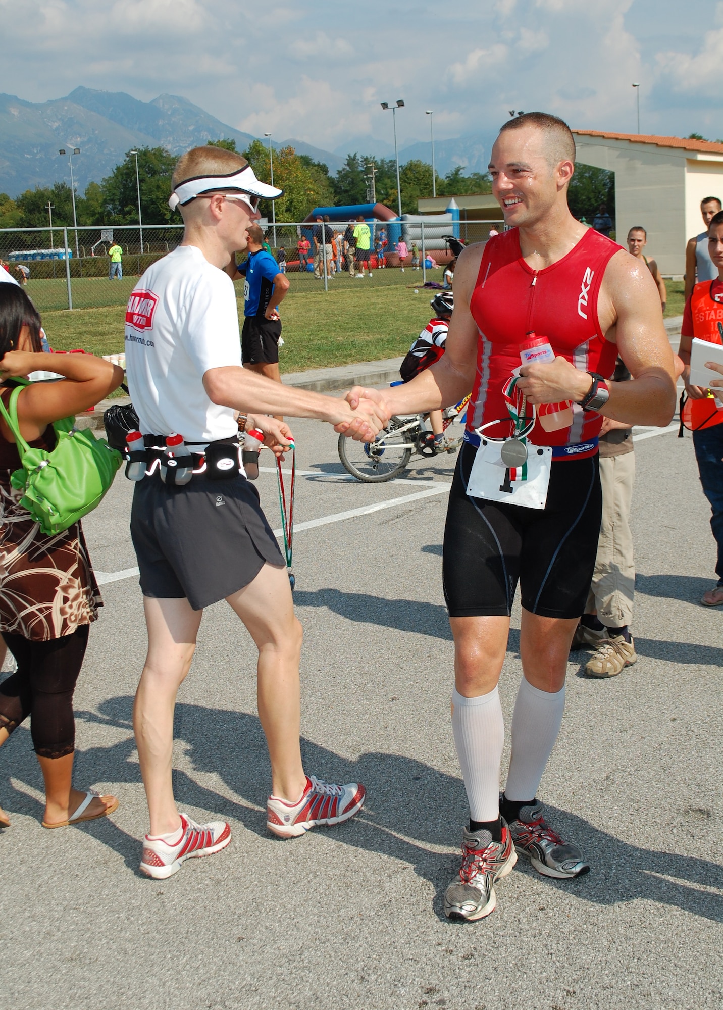 A fellow marathon runner congratulates Tech. Sgt. Brian Morris (right) on his first place finish in the Third Annual Aviano Marathon Sept. 13, 2009, held off base in and around the city of Aviano, Italy.  Sergeant Morris, 32, who previously took first place in the 2008 event held here, is stationed at Royal Air Force Mildenhall, England, and completed this year's 42-kilometer course in 3:11:03. (U.S. Air Force photo/Tech. Sgt. Michael O'Connor)