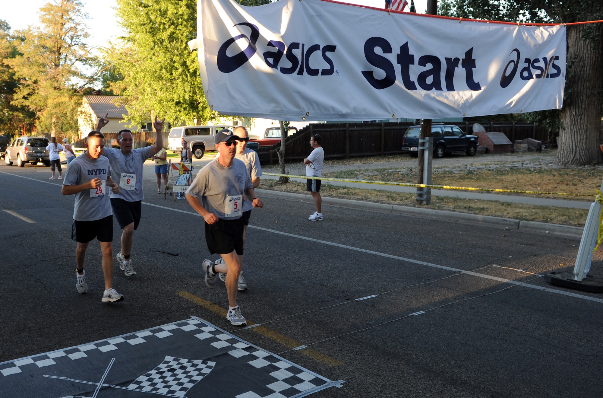 MOUNTAIN HOME AIR FORCE BASE, Idaho -- A group of contestants cross the finish line during the 49th annual Air Force Appreciation Day fun run or walk Sept. 11 in downtown Mountain Home. This year's festivities also included a corn shucking competition Sept. 11 and ended with the parade and free barbecue Sept. 12. AFAD began in 1962 as a way for the Mountain Home Chamber of Commerce to express their gratitude for the economic benefits the Air Force brought to the area and a way to encourage neighborly growth. (U.S. Air Force photo by Airman 1st Class Debbie Lockhart)