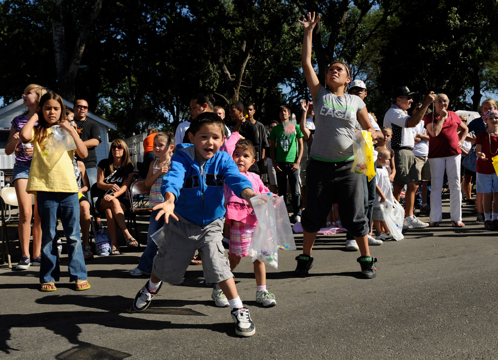 MOUNTAIN HOME AIR FORCE BASE, Idaho -- Children react as candy is thrown during the 49th annual Air Force Appreciation Day parade Sept. 12 in downtown Mountain Home. The year’s festivities began with a corn shucking competition and fun run Sept. 11 and ended with the parade and free barbecue Sept. 12. AFAD began in 1962 as a way for the Mountain Home Chamber of Commerce to express their gratitude for the economic benefits the Air Force brought to the area and a way to encourage neighborly growth. (U.S. Air Force photo by Airman 1st Class Renishia Richardson)
