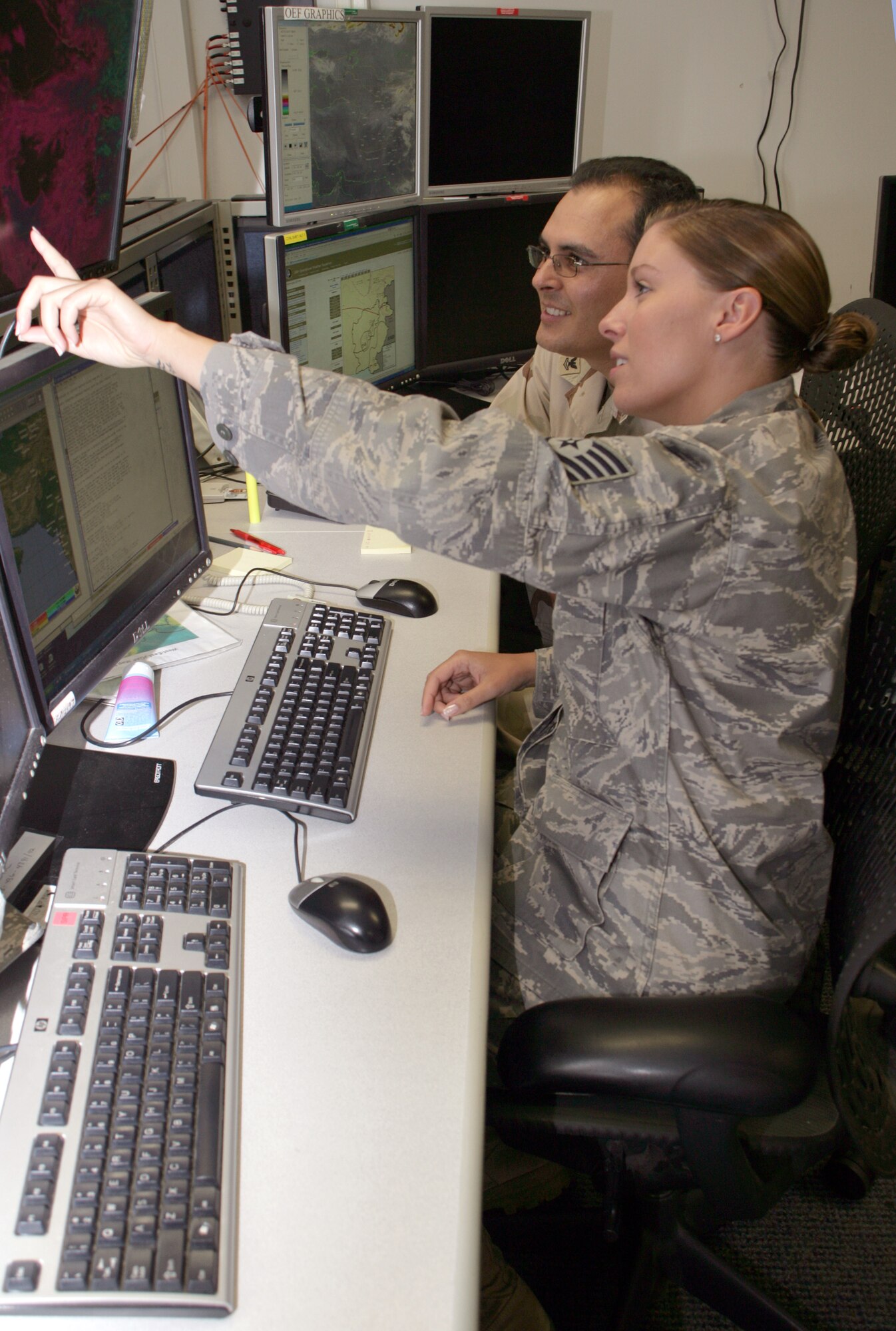 Tech. Sgt. Casey Grim and Navy Petty Officer 2nd Class Jorge Castillo both serve together at the 28th Operational Weather Squadron here as joint operational area forecasters. The combined 28th OWS team provides weather products for all branches of the U.S. military and our coalition partners in the U.S. Central Command's area of responsibility. Sergeant Grim is a reservist with the 5th Operational Weather Flight. Petty Officer Castillo is an aerographer's mate second class from Naval Station Norfolk, Va. (U.S. Air Force photo/Ryan Hansen)