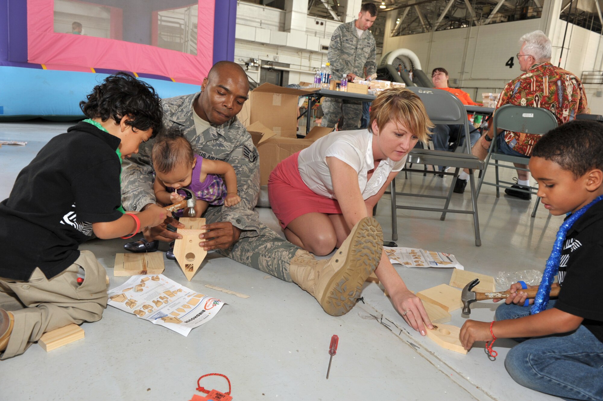 Staff Sgt. Napoleon Stanley and his wife, Tamra, help their children with building projects donated by Home Depot at the 931st Air Refueling Group's annual family day picnic on Sept. 13. Sergeant Stanley is a Reserve utilities Airman assigned to the 931st Civil Engineer Squadron. On his lap is his daughter, Nataliegh, 1; on his right is 5-year-old Christopher and to his left is 6-year-old Tagehn. (U.S. Air Force photo/Tech. Sgt. Jason Schaap)