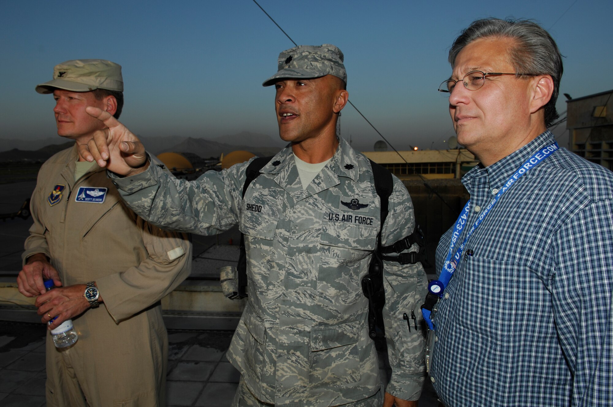 Lt. Col. Bill Shedd (center), Kabul Air Corps Training Center team lead, shows the layout of the Afghan National Army Air Corps compound to Col. Scott D. Seavers (far left), deputy director of the Air Education and Training Command International Training and Education, and Mr. S. David Spoon (far right), International Training Program Manager (Afghanistan) for the Air Force Security Assistance Training Squadron. Colonel Severs and Mr. Spoon visited the Air Corps to view the current state of in-country training objectives and discuss how AFSAT and AETC can support future training initiatives. (U.S. Air Force photo/Staff Sgt. Thomas Dow)