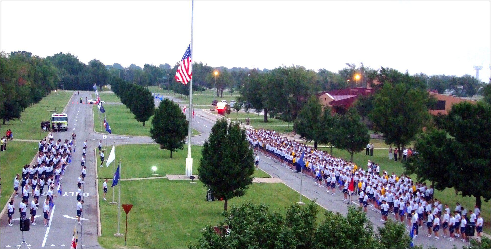 More than 1,000 Team Vance members gathered at the base flag pole Friday, Sept. 11, at Vance AFB, Okla., to observe Patriot Day on the eighth anniversary of the terrorist attacks on New York and Washington, D.C. Following the ceremony at the flag pole, the military members, and a few civilians, ran a 1.5 mile course from the wing headquarters to the Fitness Center, followed by push-ups and sit-ups. (U.S. Air Force photo/ Terry Wasson)