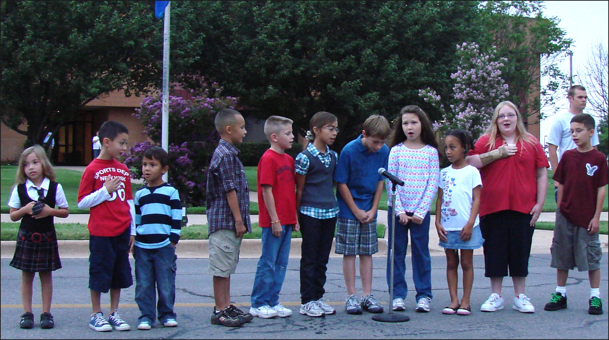 Children from Eisenhower Elementary school at Vance AFB, Okla., lead those attending the Patriot Day ceremony Sept. 11 in the Pledge of Allegiance. More than 1,000 Team Vance members gathered at the base flag pole at 7:30 a.m. for the ceremony and a 1.5 mile run. (U.S. Air Force photo/ Bob Farrell)