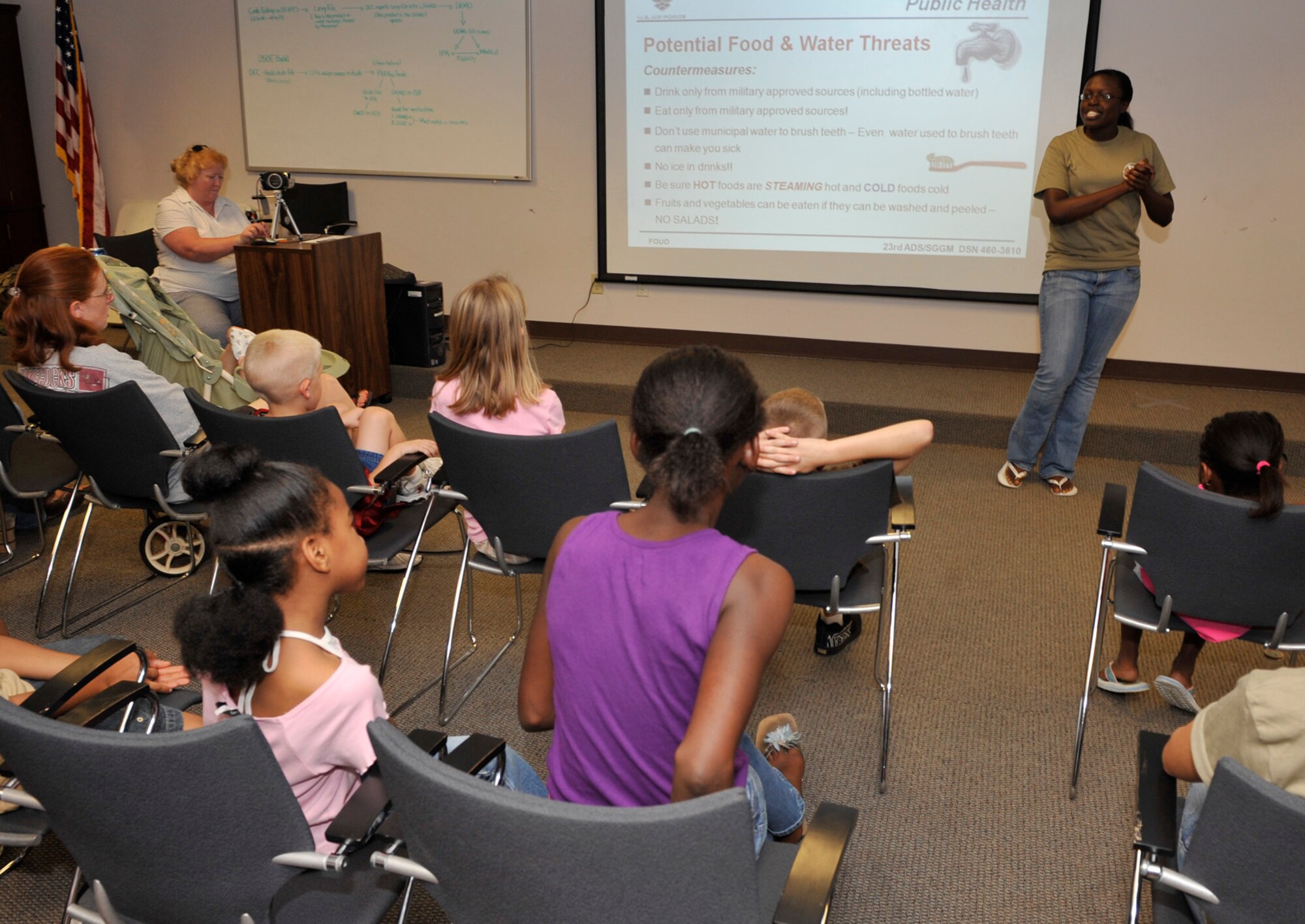 MOODY AIR FORCE BASE, Ga. -- Senior Airman Latisha Gowans, 23rd Medical Group public health technician, holds a briefing during the kids’ deployment line here Sept. 12. The children received briefings from various base organizations who informed them about what their parents go though before a deployment. (U.S. Air Force photo by Senior Airman Schelli Jones)