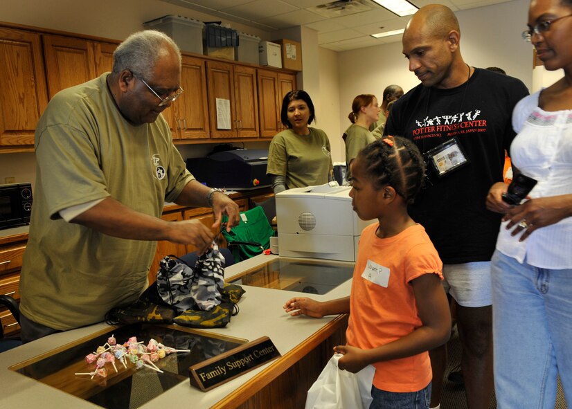 MOODY AIR FORCE BASE, Ga. -- Ernie Pryor, 23rd Force Support Squadron Airman and Family Readiness Center financial counselor, passes out goodies during the kids’ deployment line here Sept. 12. The kids’ deployment line is designed to give children an insight on what their parents go through when they deploy.  (U.S. Air Force photo by Senior Airman Schelli Jones)