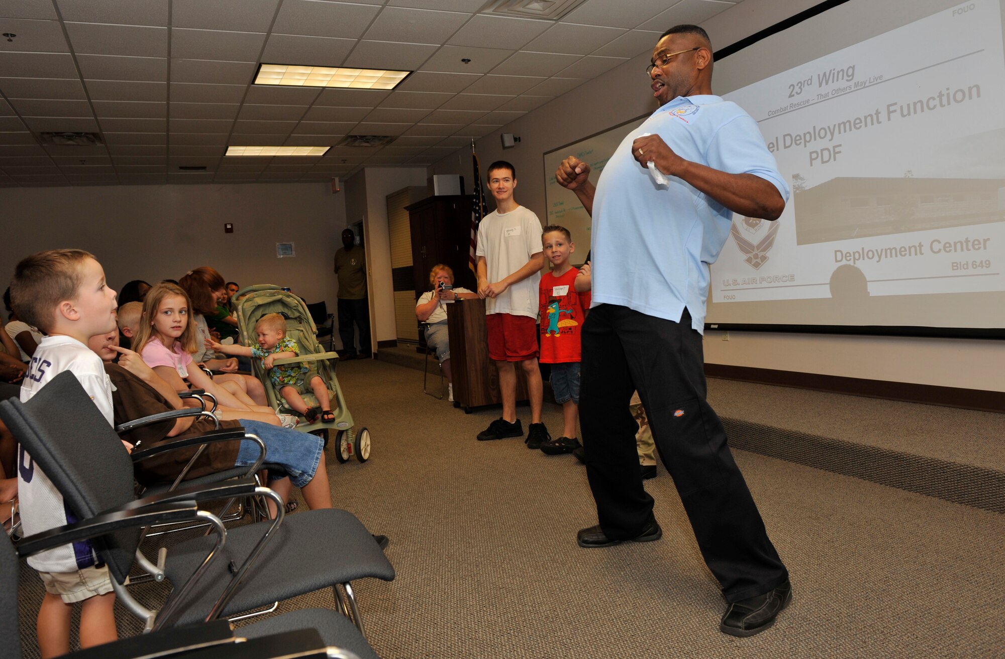 MOODY AIR FORCE BASE, Ga. -- Senior Master Sgt. Victor Johnson, 23rd Force Support Squadron Airman and Family Readiness Center superintendent, gives an animated pre-briefing during the kids’ deployment line here Sept. 12. The kids’ deployment line is a simulated deployment for youth so they can experience what this part of a deployment is like for their military parent. (U.S. Air Force photo by Senior Airman Schelli Jones)