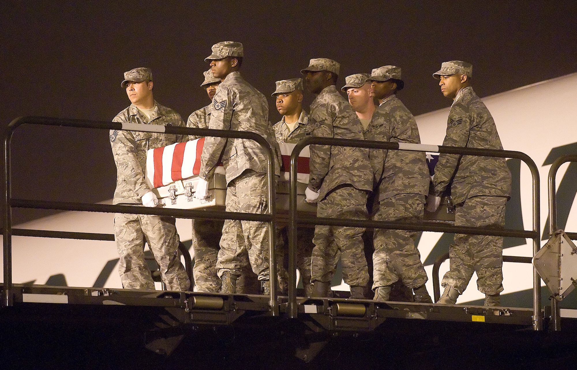 DOVER AIR FORCE BASE, Del.- Staff Sgt. Michael Bishop, far left, 446th Services Flight, McChord Air Force Base, Wash., helps the Port Mortuary Carry Team transfer the remains of Senior Airman Ashton Goodman, of Indianapolis, here, May 28. Sergeant Bishop was assigned to the Air Force Mortuary Operations Center for two consecutive air expeditionary force rotations. Airman Ashton was assigned to the 43rd Logistics Readiness Squadron, Pope Air Force Base, N.C. (U.S. Air Force photo/Jason Minto)