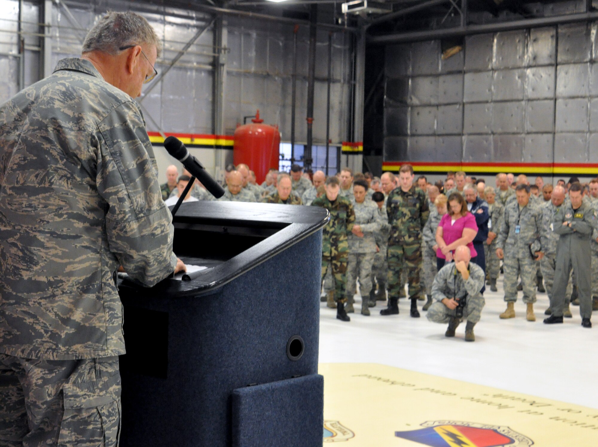 Members of the 419th Fighter Wing bow their heads during a moment of silence led by the wing’s Chaplin Lt. Col. Craig Rodgers in remembrance of the attacks of September 11, 2001 during the Wing Commander’s Call on September 13, 2009. (U.S. Air Force Photo/Staff Sgt. Kyle Brasier)