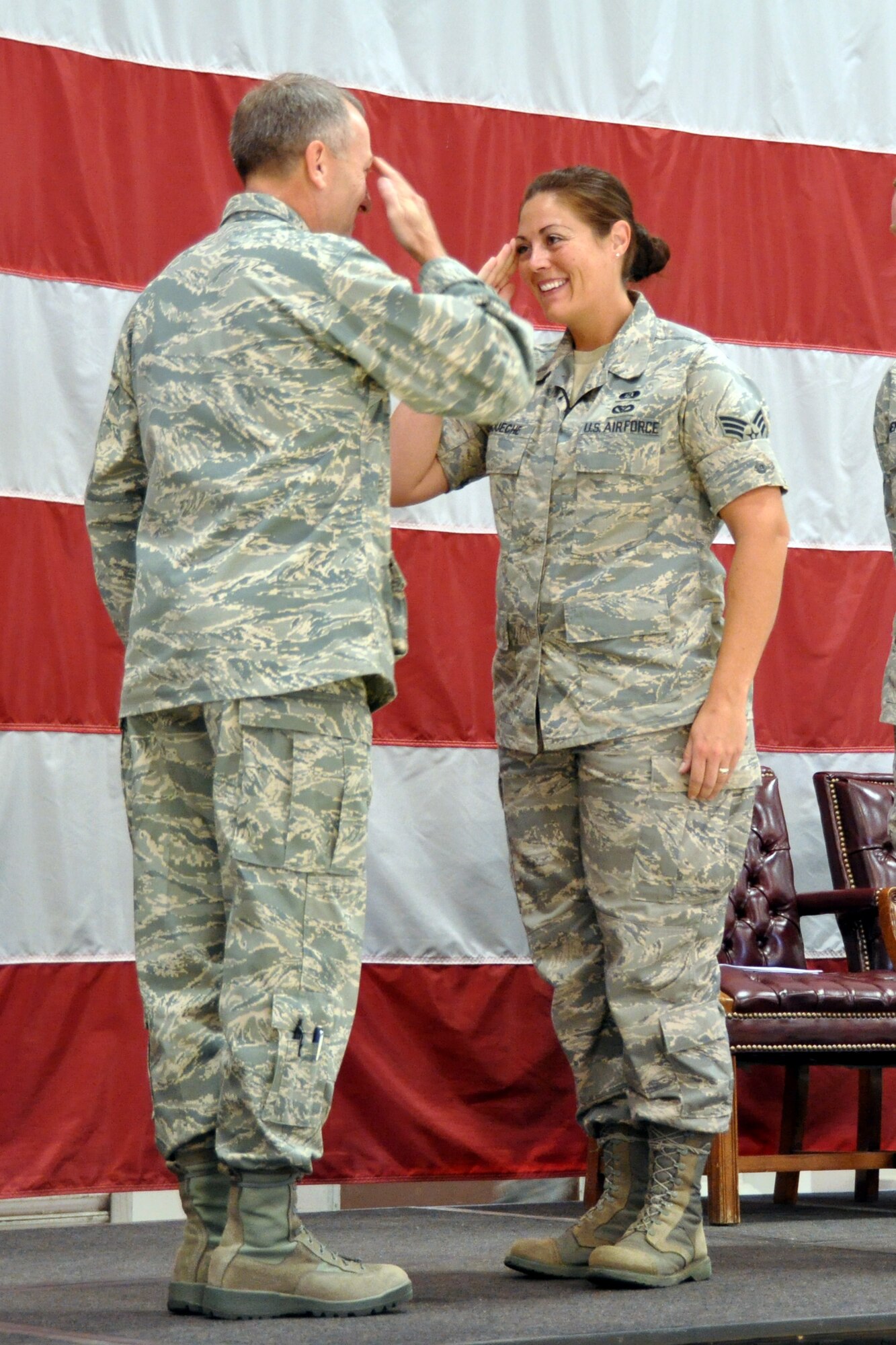 Colonel Walter J. Sams, 419th Wing Commander, gives a coin to Senior Airman Jenna Roueche, 419th Civil Engineering Squadron, for winning Air Force Reserve Command’s Emergency Manager of the Year award. (U.S. Air Force photo by Senior Airman Brandon Craig)