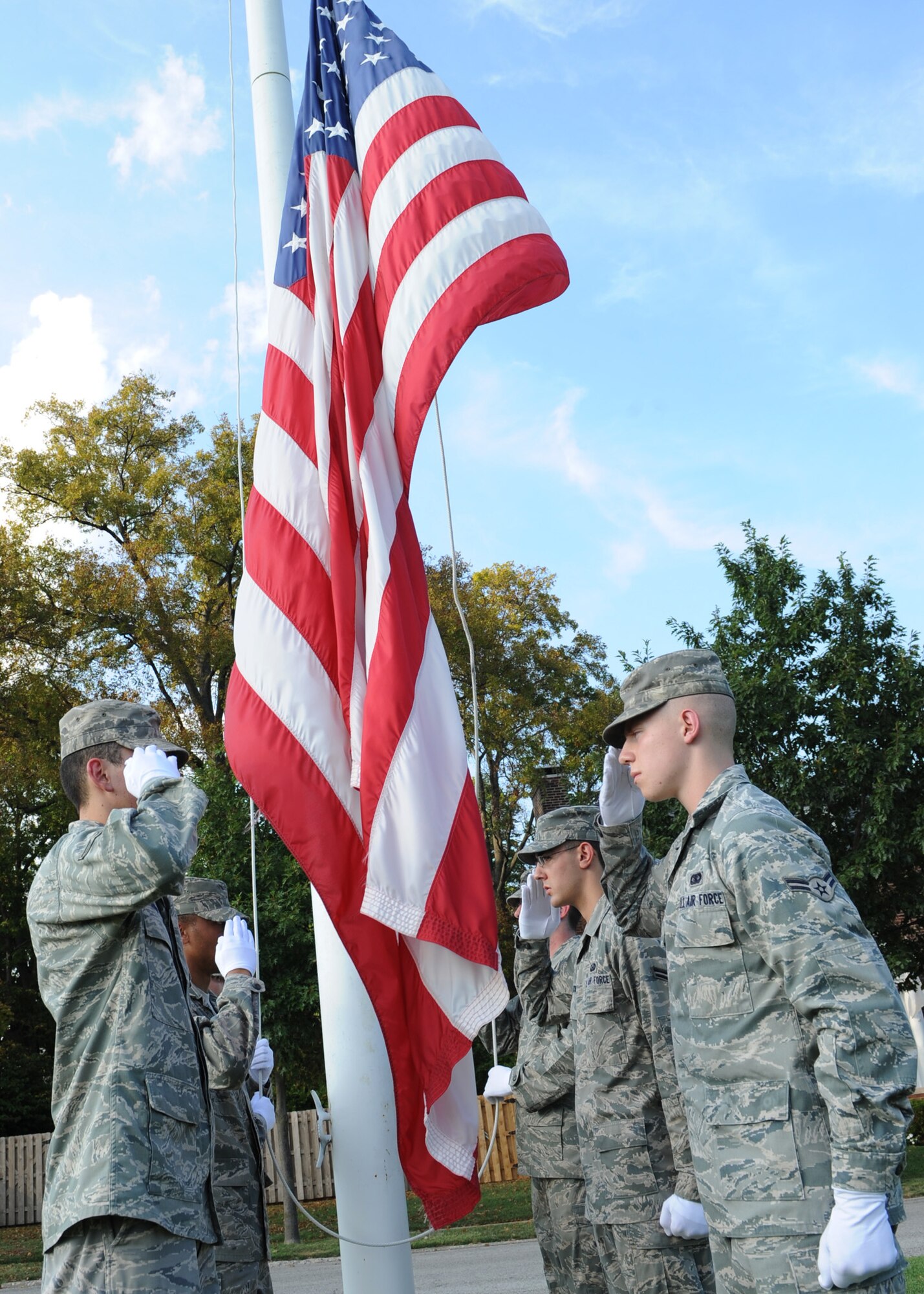 Scott Air Force Base, Ill – Members of the Scott AFB Honor Guard render a salute as the flag is lowered during the September 11 retreat Friday on the parade field. Members of Team Scott gathered to pay tribute to those that lost their lives on 9/11. (U.S. Air Force photo by Airman 1st Class Wesley Farnsworth)