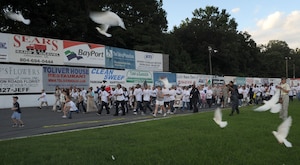 LANGLEY AIR FORCE BASE, Va. --   Langley Airmen and local community members participate in Freedom Walk, as doves are released at Langley Speedway Sept. 11. Freedom Walk was held in remembrance of those lost during 9/11 terrorist attacks and to honor our military members and first responders.  (U.S. Air Force photo/Senior Airman Zachary Wolf)