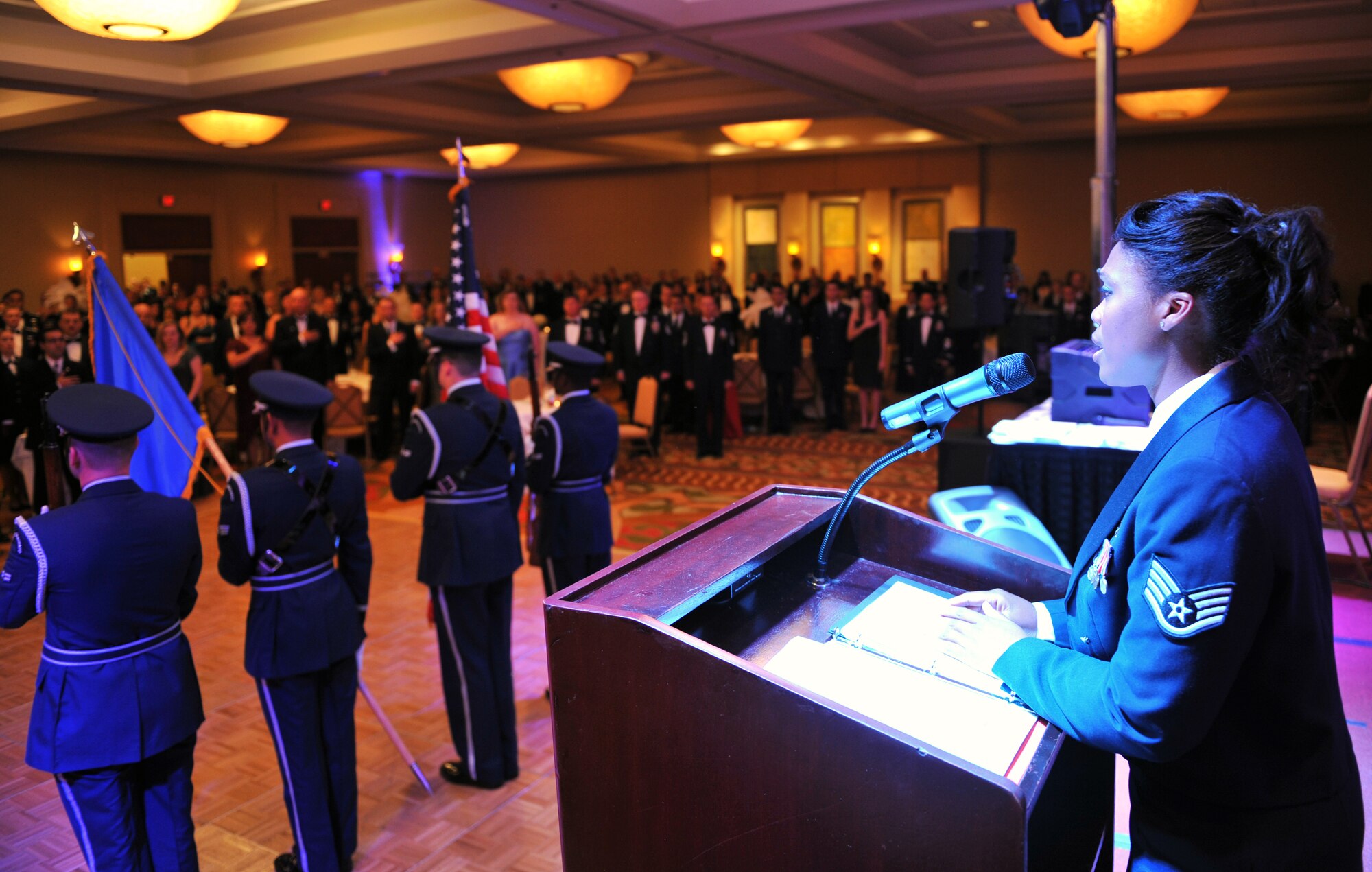 Staff Sgt. LaTanza Meabon-Whiteside, 19th Logistics Readiness Squadron, sings the national anthem while members off the base honor guard present the colors during the 2009 Air Force Ball Sept. 12 at the Peabody Hotel in Little Rock, Ark. Highlights of the event included performances by talented base singers and an Elvis impersonator as base personnel and community leaders celebrated the Air Force’s 62nd birthday together. (U.S. Air Force photo by Staff Sgt. Chris Willis)