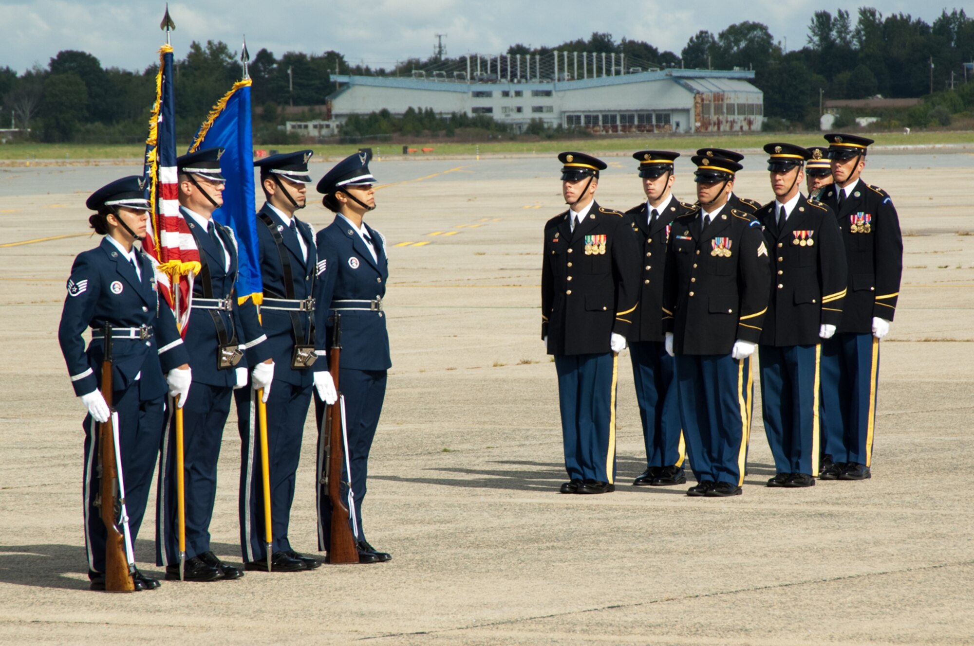 HANSCOM AIR FORCE BASE, Mass. –Members of the Hanscom Patriot Honor Guard (left) stand at attention alongside the U.S. Army Honor Guard detail (right) during a dignified transfer of remains ceremony Sept. 10, for Army Sergeant Jordan Shay of Amesbury, Mass. who died Sept. 2 in Iraq. Sergeant Shay was assigned to the 5th Battalion, 20th Infantry Regiment, 2nd Infantry Division based in Fort Lewis, Washington.  (U.S. Air Force photo by Rick Berry)