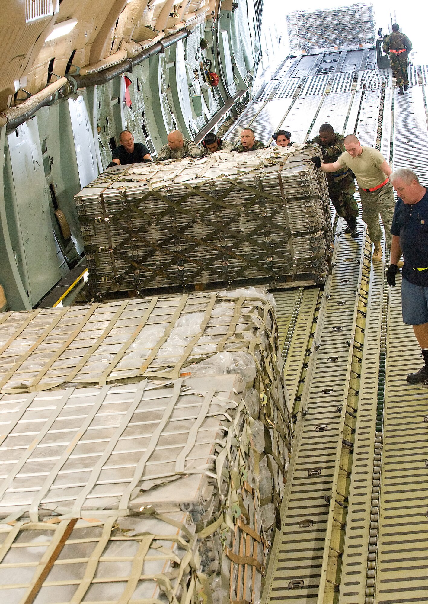 Members of the 436th and 46th Aerial Port Squadron load weighted pallets onto the C-5M Super Galaxy, "The Spirit of Normandy", Sept. 12. The pallets were the payload weight for the C-5M for its world record breaking attempt Sept. 13. (U.S. Air Force photo/Jason Minto)