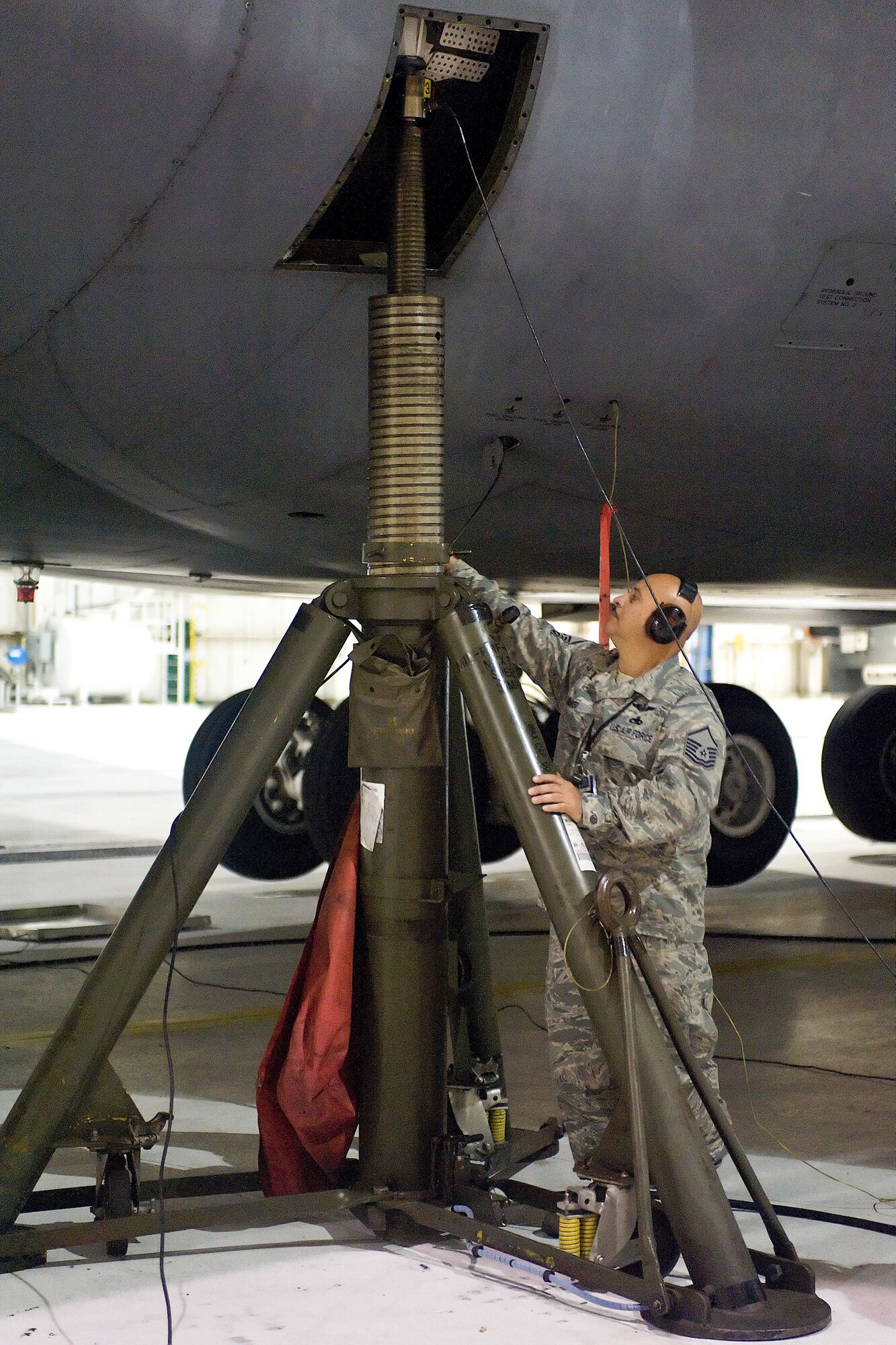 Master Sgt. Richard Biasi, 512th Aircraft Maintenance Squadron dedicated crew chief of aircraft, "The Spirit of Normandy", overviews a jack supporting the C-5M Super Galaxy during its weighing Sept. 11. The (U.S. Air Force photo/Roland Balik)