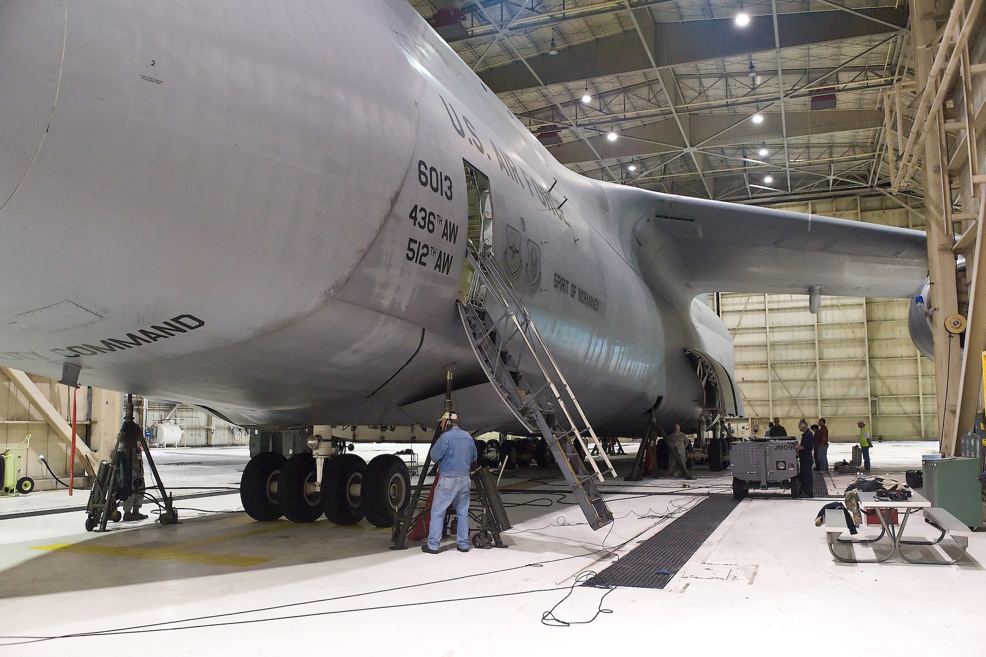 Maintainers position jacks before raising a C-5M Super Galaxy, "The Spirit of Normandy", Sept.11 in preparation for a weighing before an attempt to break 33 world records in demonstration of the Aircraft's abilities. (U.S. Air Force photo/Roland Balik)
