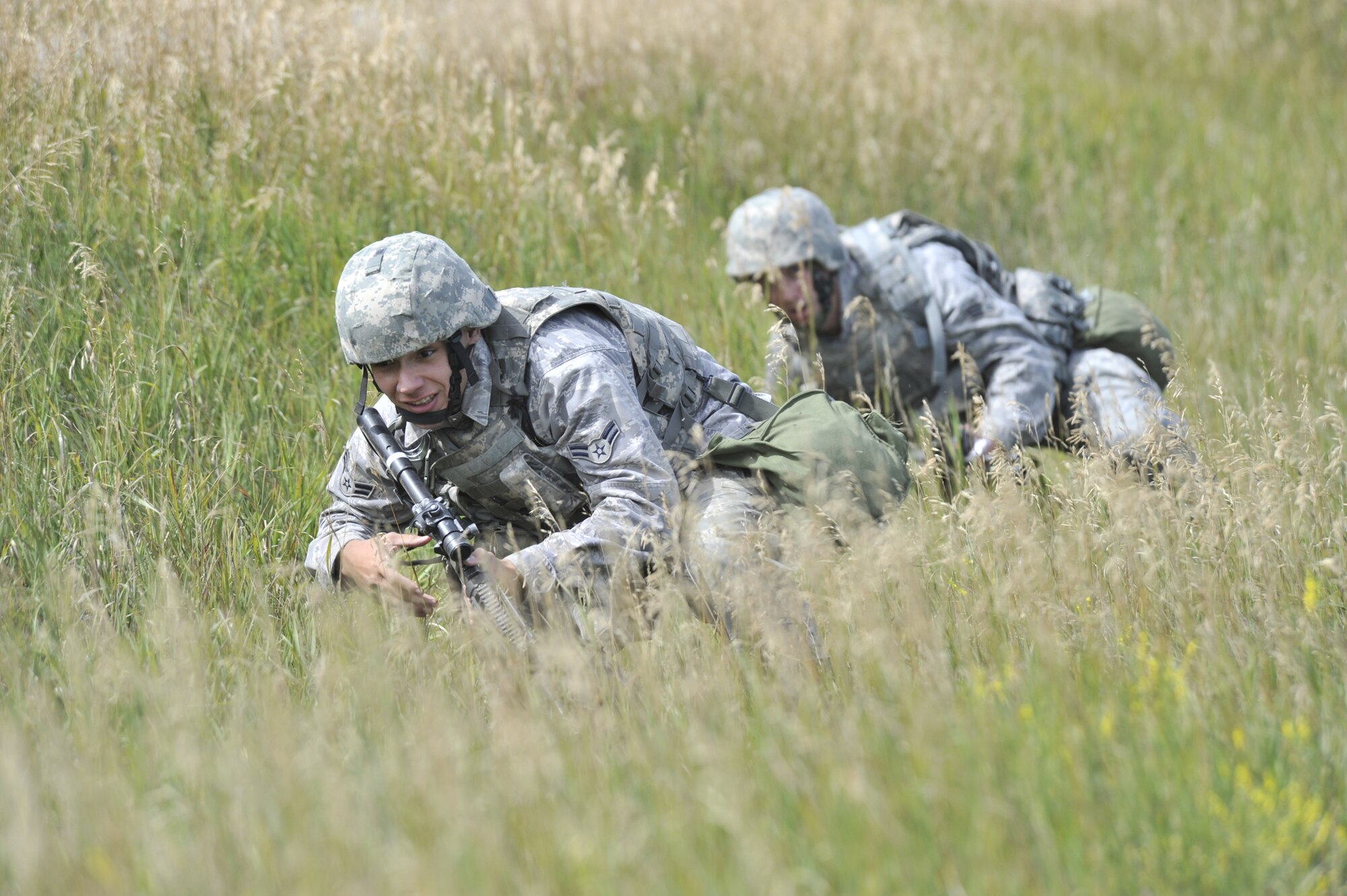 Airman 1st Class Oscar D'Lassalas leads the way for Senior Airman Brian Sellers during the Hotel 03 Denial Exercise that was graded during the Combat Capability Evaluation. Malmstrom passed the exercise, successfully denying the "enemy" access to the site. (U.S. Air Force photo/John Turner)
