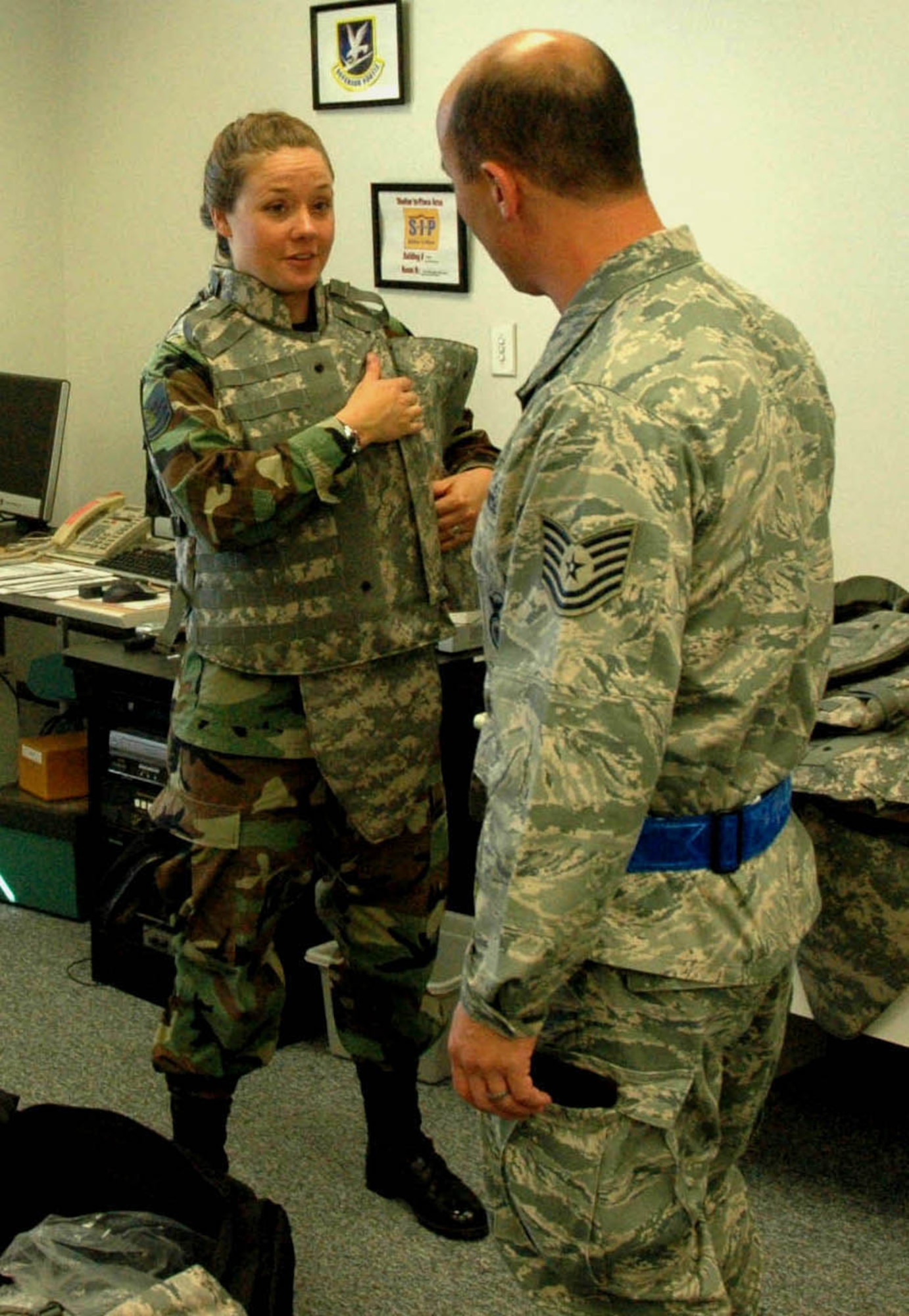 MCCHORD AIR FORCE BASE, Wash.- Tech. Sgt. Vanessa Walsh, left, 446th Security Forces Squadron here, tests out a new bulletproof vest as she and fellow security forces teammate, Tech. Sgt. Ric Shumate, examine a new shipment of equipment in the 446th SFS training room here, Sept. 12. When not serving in the Air Force Reserve, Sergeant Walsh teaches sixth grade students in the Bethel School District in Spanaway, Wash. (U.S. Air Force photo/Staff Sgt. Nicole Celestine). 