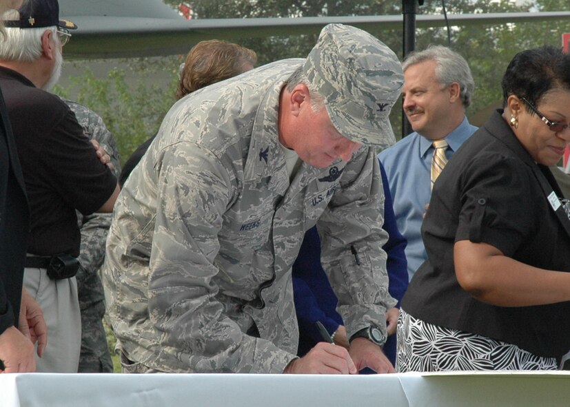 Colonel Weeks signs the community covenant during a ceremony held Sept. 1 at the Northwest Florida Regional Airport. (U.S. Air Force photo/Dan Neely)