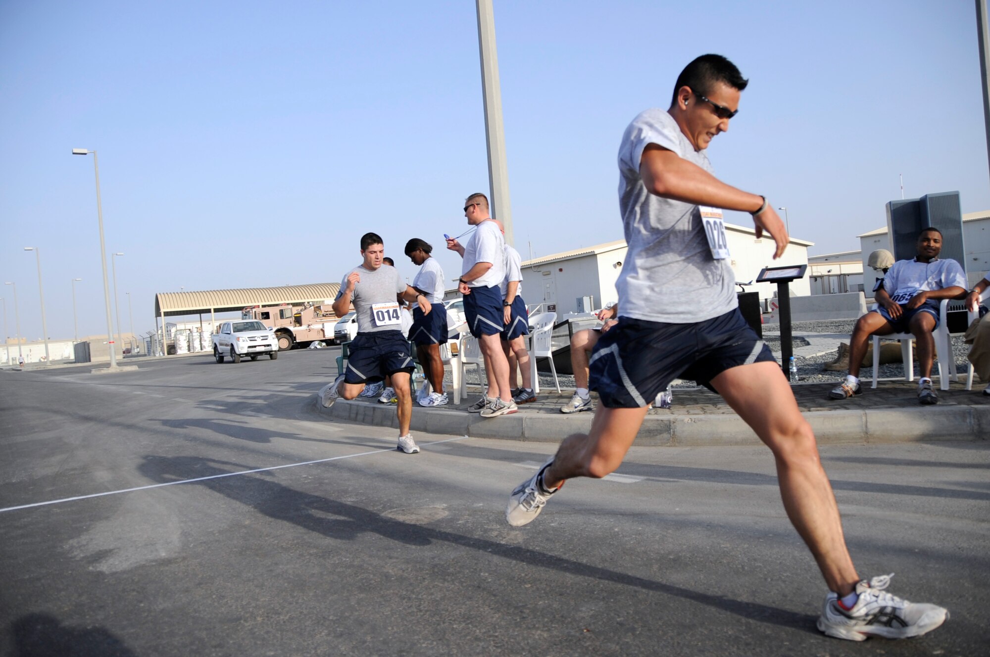 SOUTHWEST ASIA - Staff Sgt. Derrick Johnson, 380th Expeditionary Logistics Readiness Squadron, and Senior Airman Andrew Vincent, 380th Expeditionary Force Support Squadron, pass the finish line at the 13th Annual Air Force Marathon here Sept. 13. Sergeant Johnson finished the half-marathon in 1:41:15, and Airman Vincent finished the same race in 1:41:16. Sergeant Johnson is deployed from Royal Air Force Mildenhall, United Kingdom, and grew up in Arlington, Texas. Airman Vincent is deployed form Barksdale Air Force Base, La., and hails from Hastings, Mich. (U.S. Air Force photo /Senior Airman Stephen Linch)