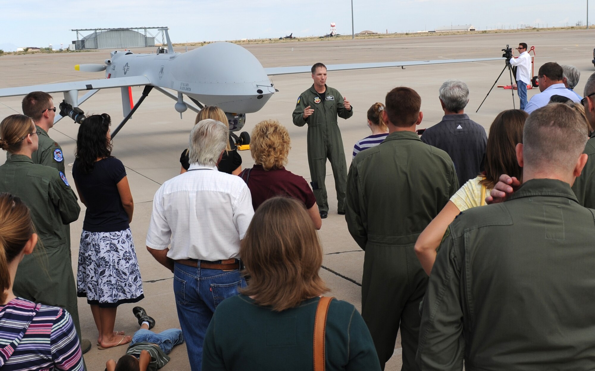 HOLLOMAN AIR FORCE BASE, N.M. -- Col. Kevin Robbins, 49th Fighter Wing vice commander, briefs a crowd of local media, distinguished visitors and members and their families of the 432nd Wing Detachment 5 here Sept. 10 after the MQ-1 Predator returned from its first official flight out of the base. With the flight, Detachment 5, reached initial operational capacity at Holloman. (U.S. Air Force photo by Senior Airman Michael Means)