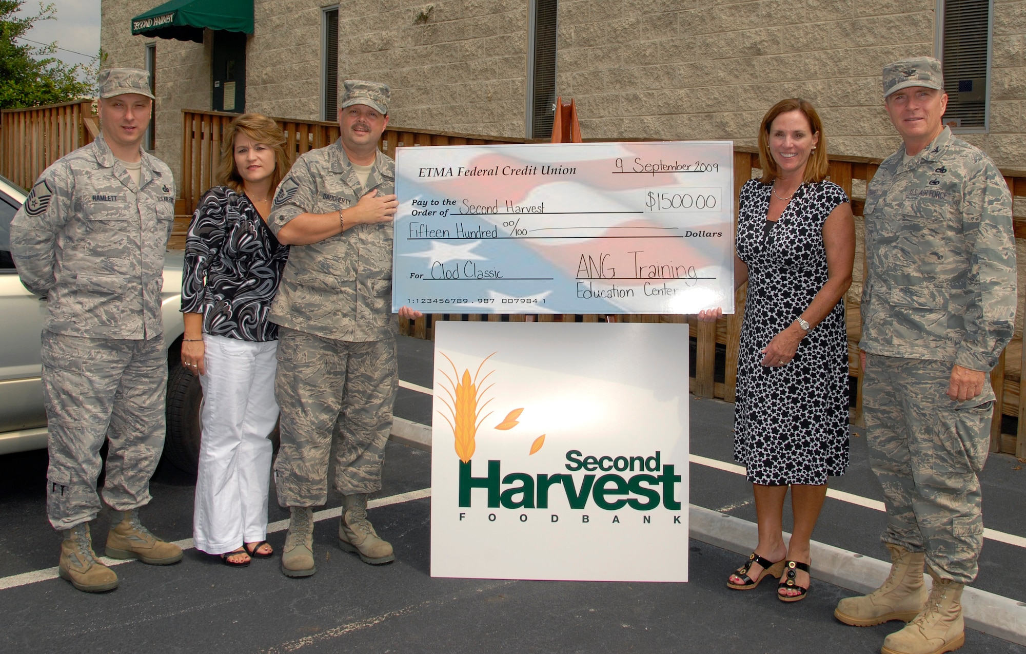 McGHEE TYSON AIR NATIONAL GUARD BASE, Tenn. --  Servicemembers from The I.G. Brown Air National Guard Training and Education Center present a check for $1,500 to the Second Harvest Food Bank of East Tennessee at its distribution center in Knoxville on Sept. 9.  The Training and Education Center raised the funds at their 2009 Clod Classic golf tournament, from left to right are Master Sgt. Harry E. Hamlett, Tammie S. Smeltzer, Master Sgt. Sam S. Daugherty, Elaine Streno, executive director of Second Harvest Food Bank of East Tennessee, and Col. Richard B. Howard. (U.S. Air Force photo by Staff Sgt. Jessica Parks)(Released)