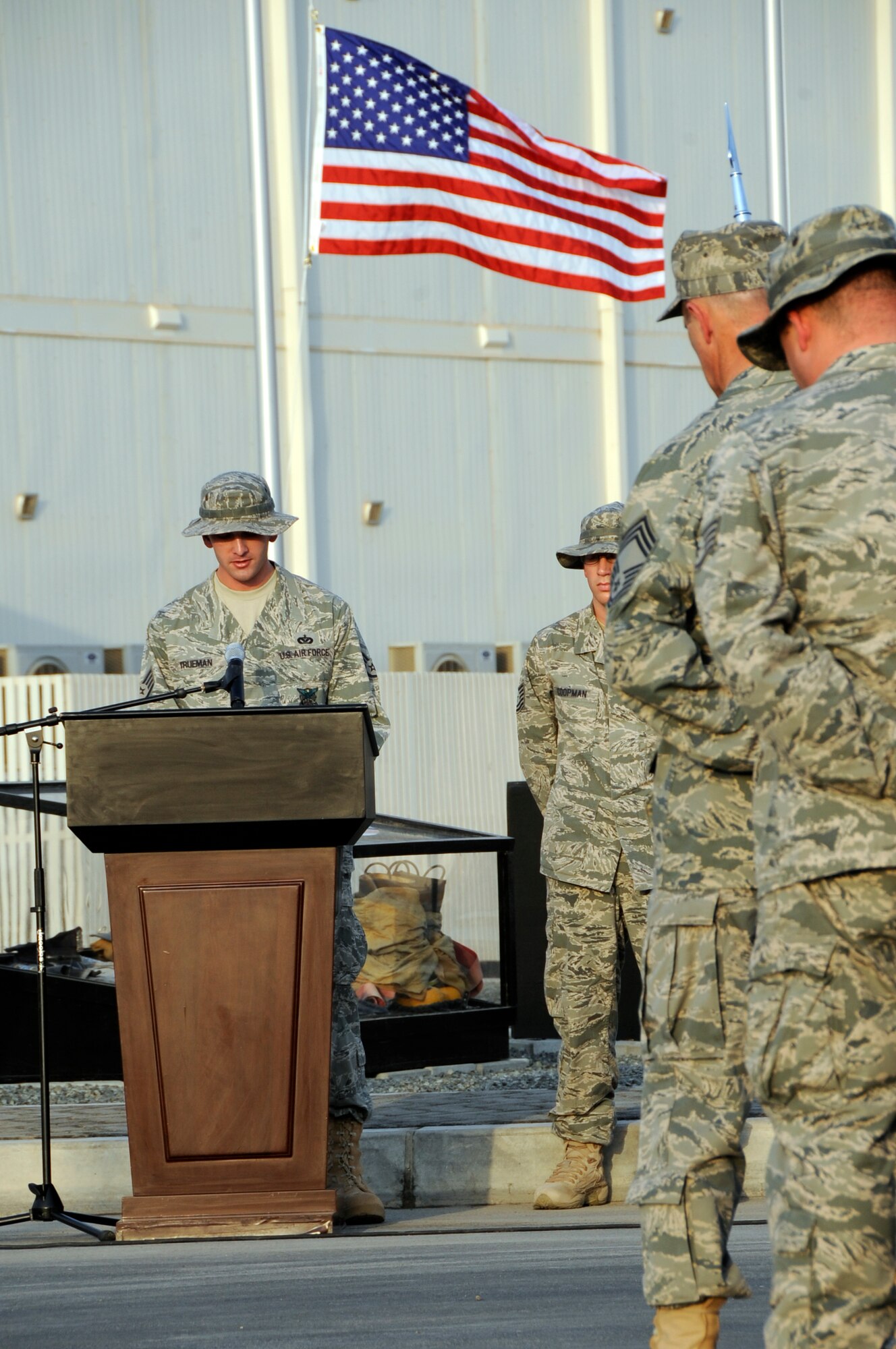 SOUTHWEST ASIA – Staff Sgt. Jeffrey Trueman, 380th Expeditionary Civil Engineer Squadron, recites the Firefighter’s Prayer during a commemoration ceremony marking the eighth anniversary of Sept. 11, 2001, here, Sept. 11, 2009. The memorial consists of a replica of the World Trade Center and three display cases: one dedicated to United Airlines Flight 93, one dedicated to the Pentagon and one dedicated to the firefighters and policemen who gave the ultimate sacrifice Sept. 11, 2001. (U.S. Air Force photo/Senior Airman Stephen Linch)